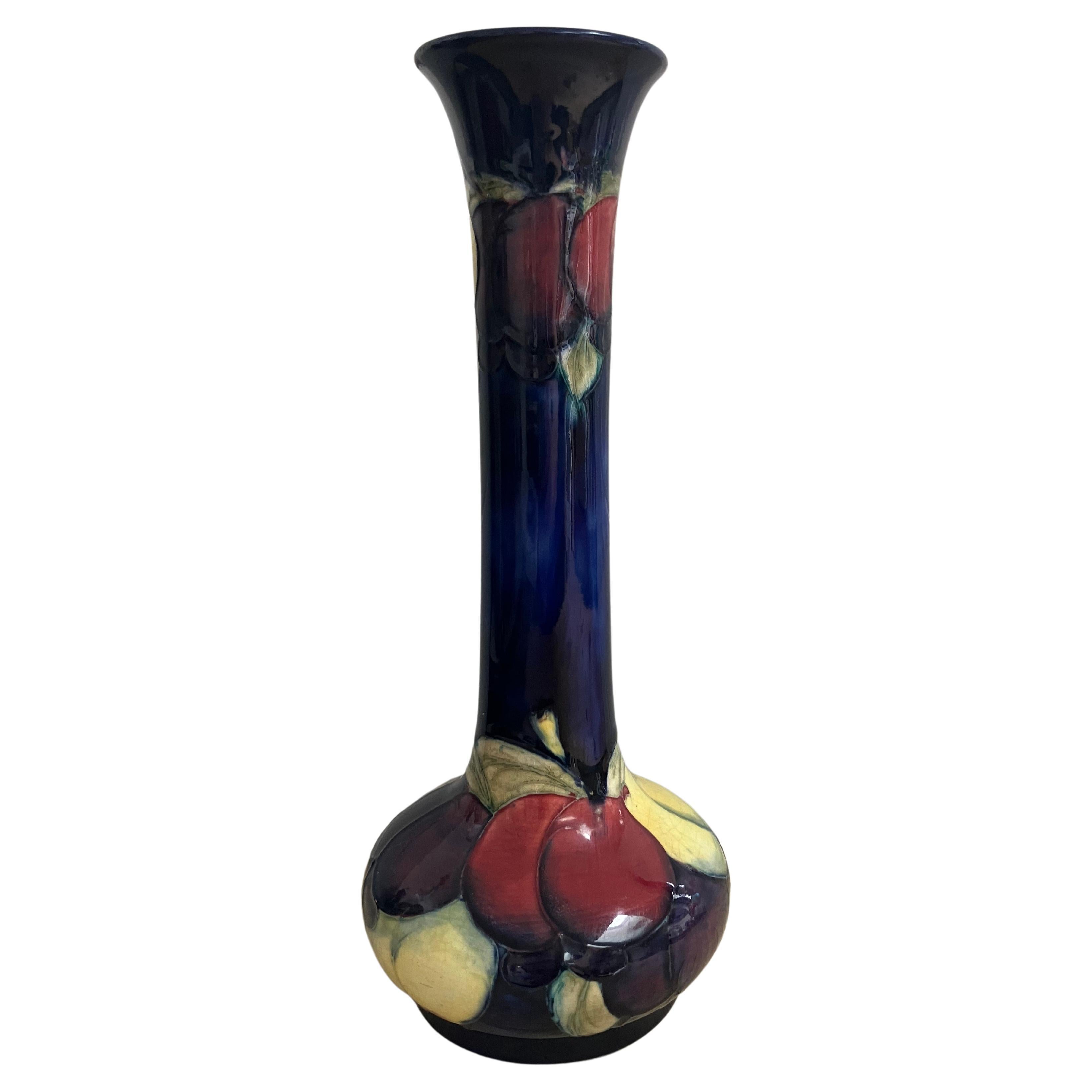 A rare, elegantly shaped, large, William Moorcroft Wisteria and plum patterned signed vase. The vase has a stunning cobalt blue ground with yellow, pink and purple wisteria plums.
An excellent piece for the serious Moorcroft collector, made in