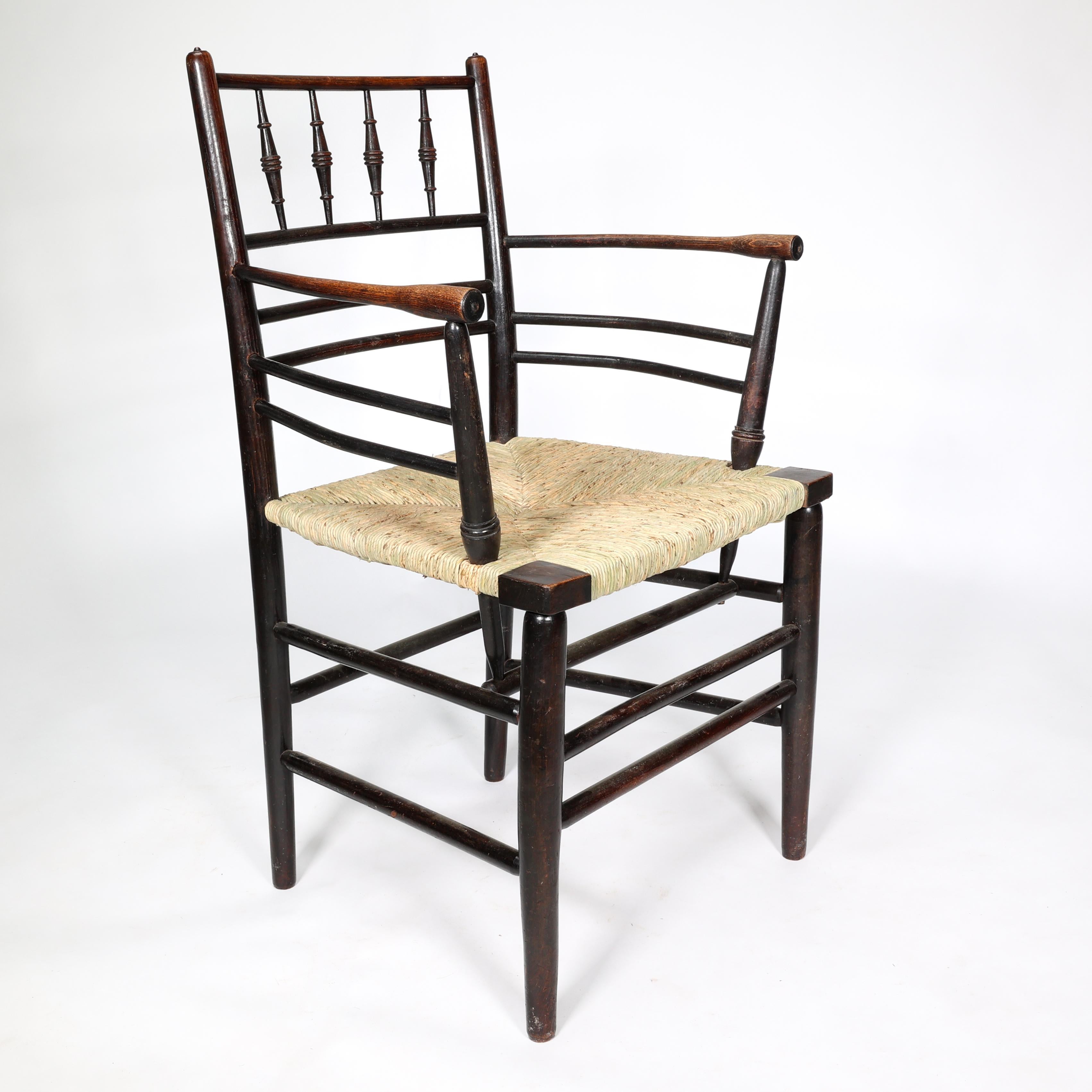 William Morris,  A classic Sussex Arts & Crafts ebonised armchair from the Sussex range.
Fully restored with a new rush seat. 
We have been restoring Sussex armchairs for over 30 years and to be fully restored correctly with a new rush seat, we