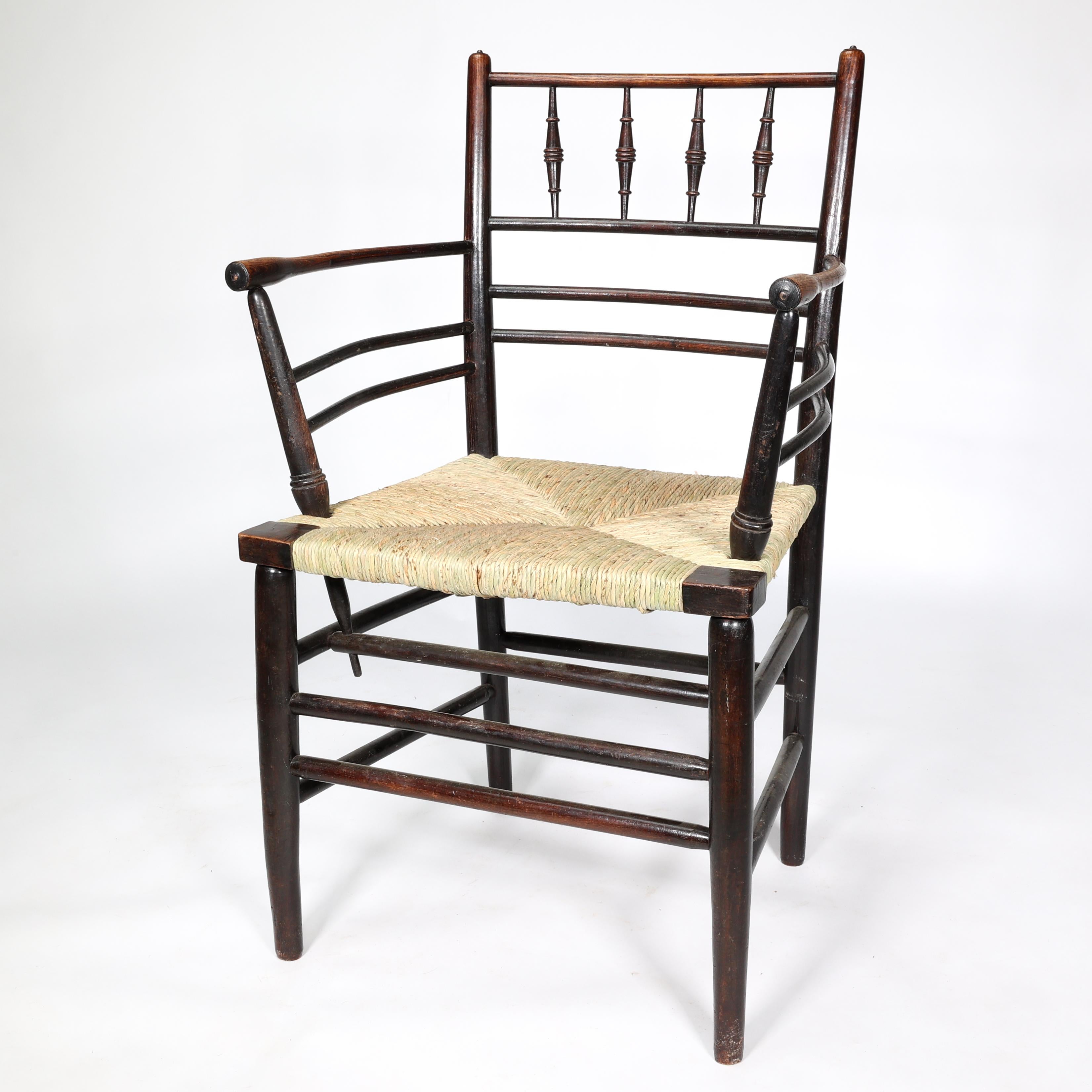 English William Morris, A Classic Arts & Crafts Ebonised Armchair from the Sussex Range.