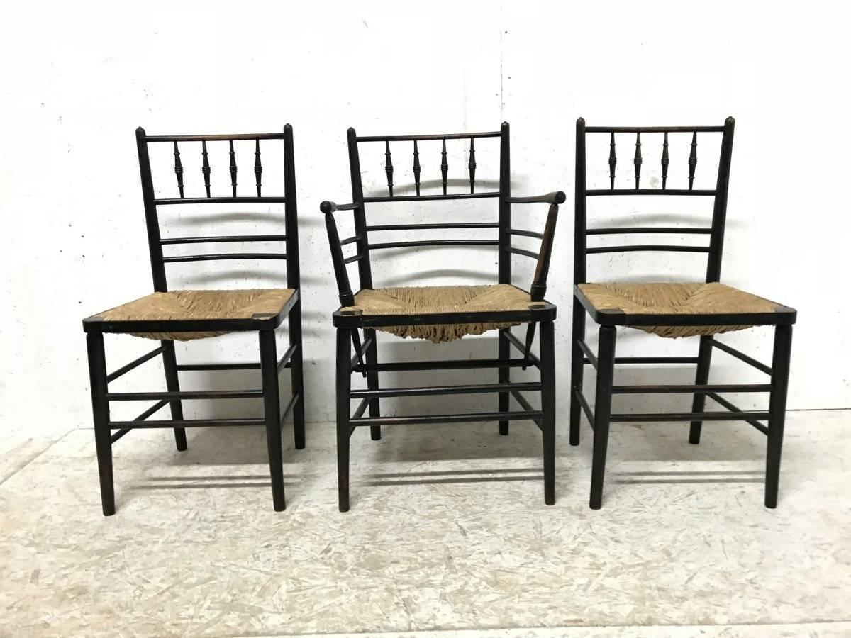William Morris, five ebonized rush seat Sussex side chairs and a matching armchair.
These consist of a single armchair and a matching pair of side chairs, a single side chair and another pair of matching side chairs that have seagrass seats which