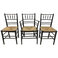 Antique William Morris, Five Ebonized Rush Seat Sussex Side Chairs and Matching Armchair