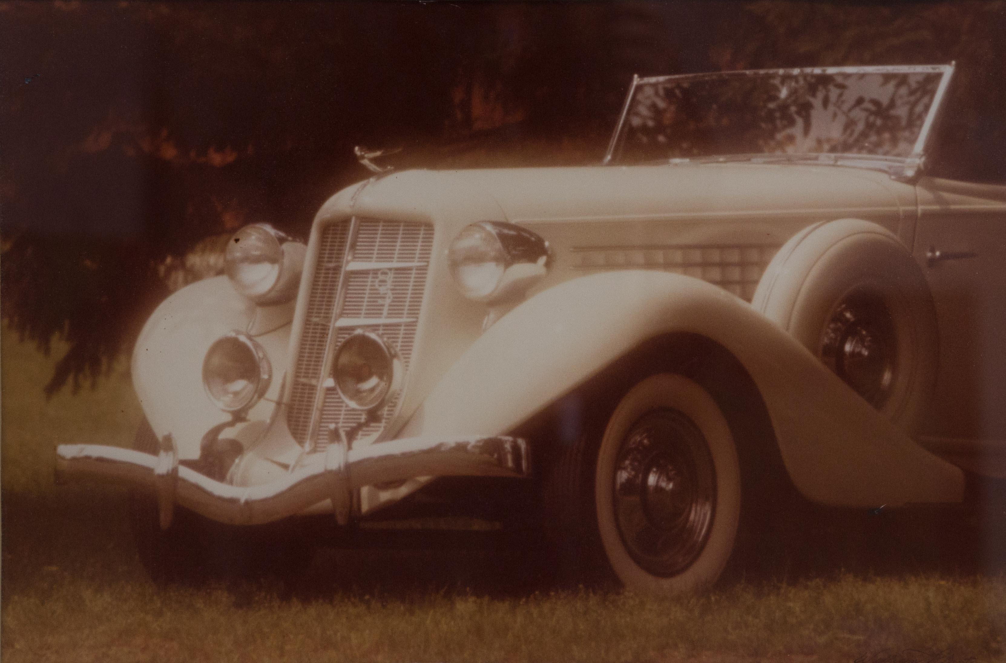 Offered is a signed William Plante original signature large folio vintage sepia toned silver print of a 1935 Auburn automobile. This speedster design by engineer Gordon Buehrig, was launched in Auburn’s final year. The work measures 24” x 32” and