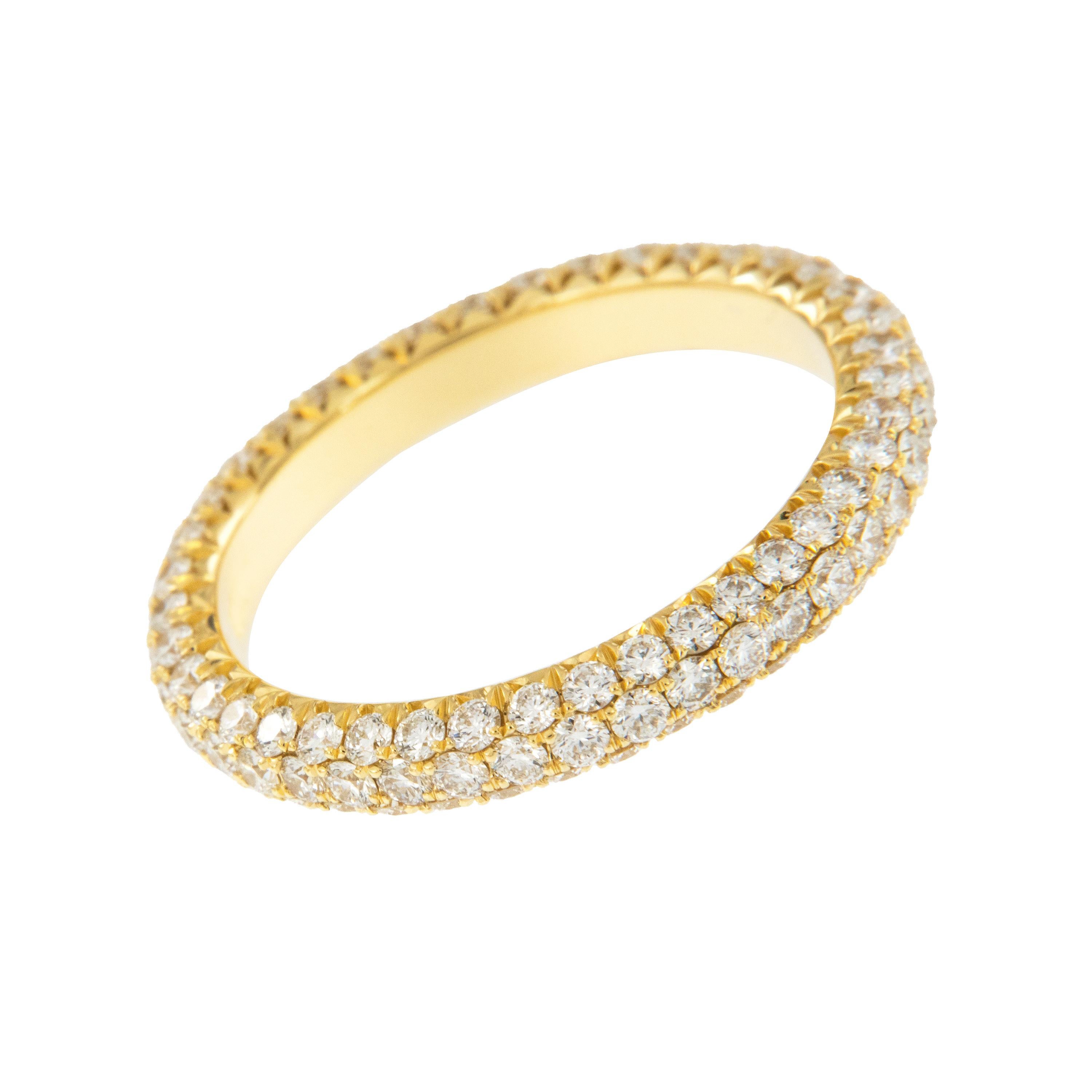 Expertly crafted eternity band by William Rosenberg made from 18 karat royal yellow gold with 3 row pave' set round brilliant diamonds = 1.49 Cttw. These exceptional diamonds are of VS clarity & D-F color. This ring was made in a size 6 but can be