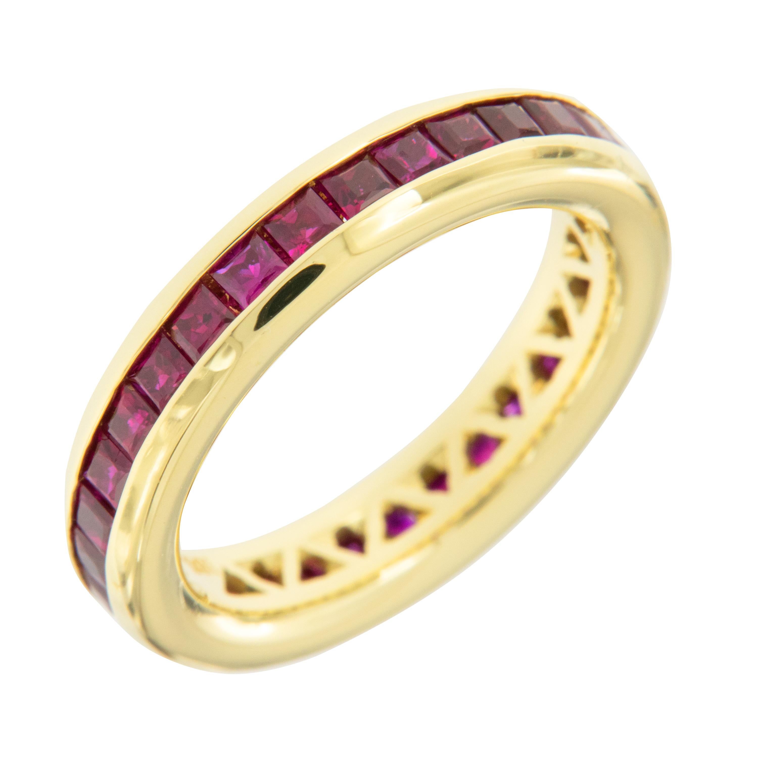 Expertly hand fabricated ring in royal 18 karat yellow gold with perfectly channel set 2.50 Cttw princess cut rubies by William Rosenberg. The classic color combination of fine red rubies & royal 18 karat yellow gold will always be a knockout! This