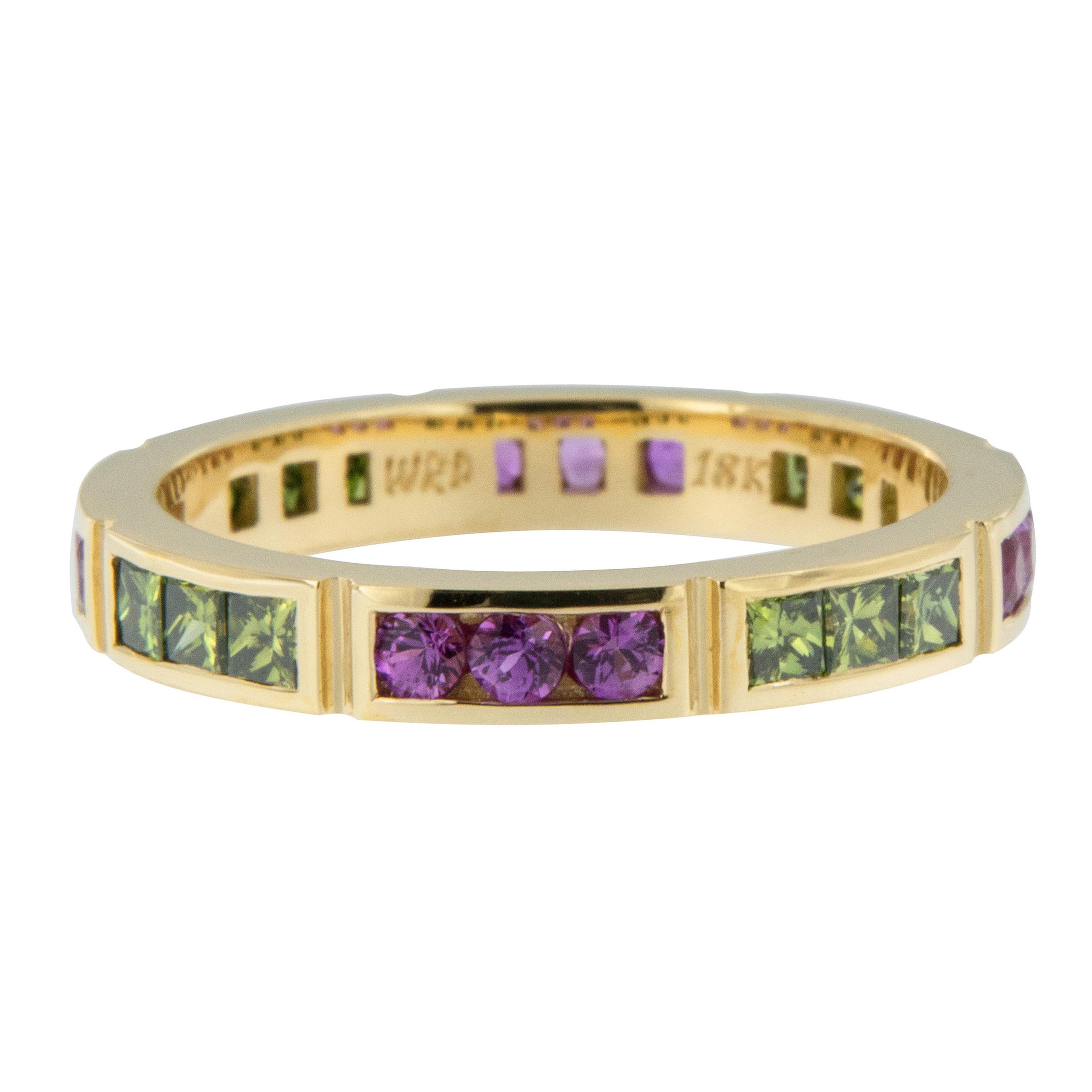 Complimentary pink & green colors set this segmented eternity ring apart from all others! Expertly hand fabricated eternity band by William Rosenberg made from rich 18 karat yellow gold with 0.54 Cttw pink sapphires & 0.63 Cttw treated green