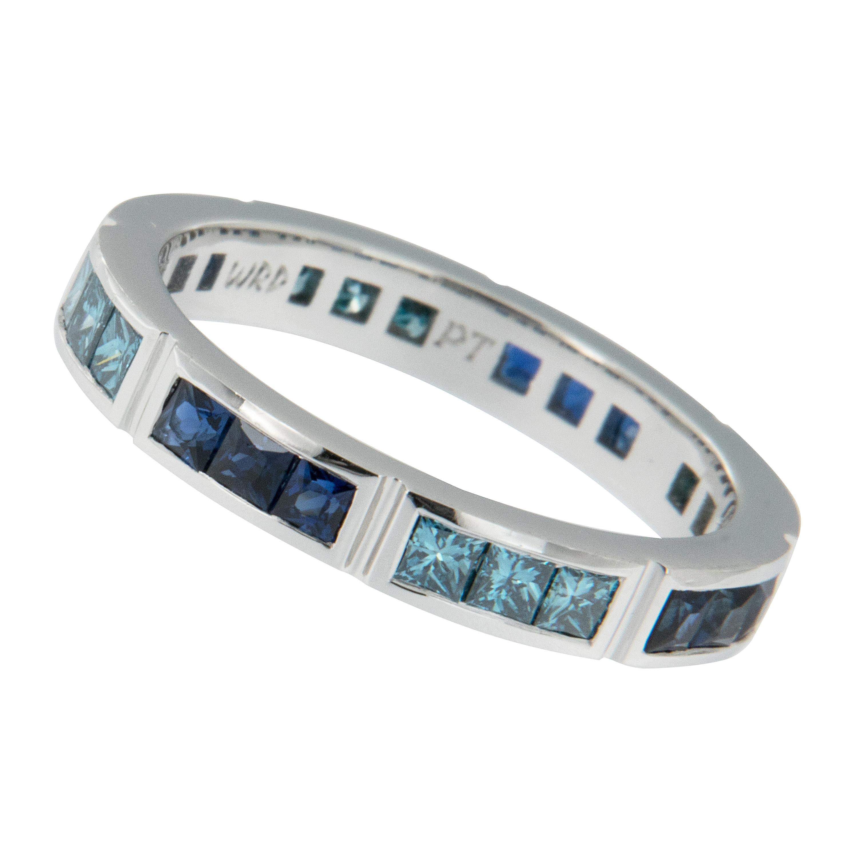 Soothing blue hues set this segmented eternity ring apart from all others! Expertly hand fabricated eternity band by William Rosenberg made from noble platinum with 0.76 Cttw blue sapphires & 0.67 Cttw treated blue diamonds. This ring was made in a