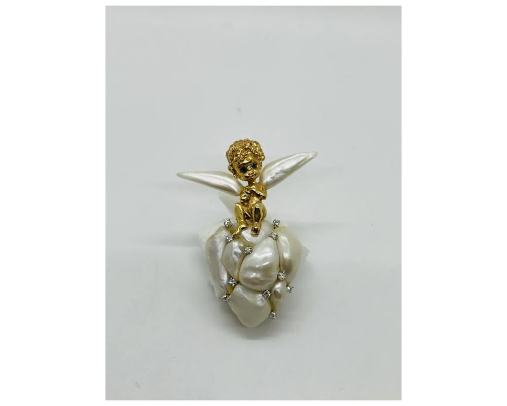 William Ruser 14K Gold Cupid Cherub Angel Brooch Set With Pearls

In great condition Ready to Wear

Size is approximately 2 ½ inches long by 2 inches wide at the widest point

Due to the item's age do not expect items to be in perfect condition and