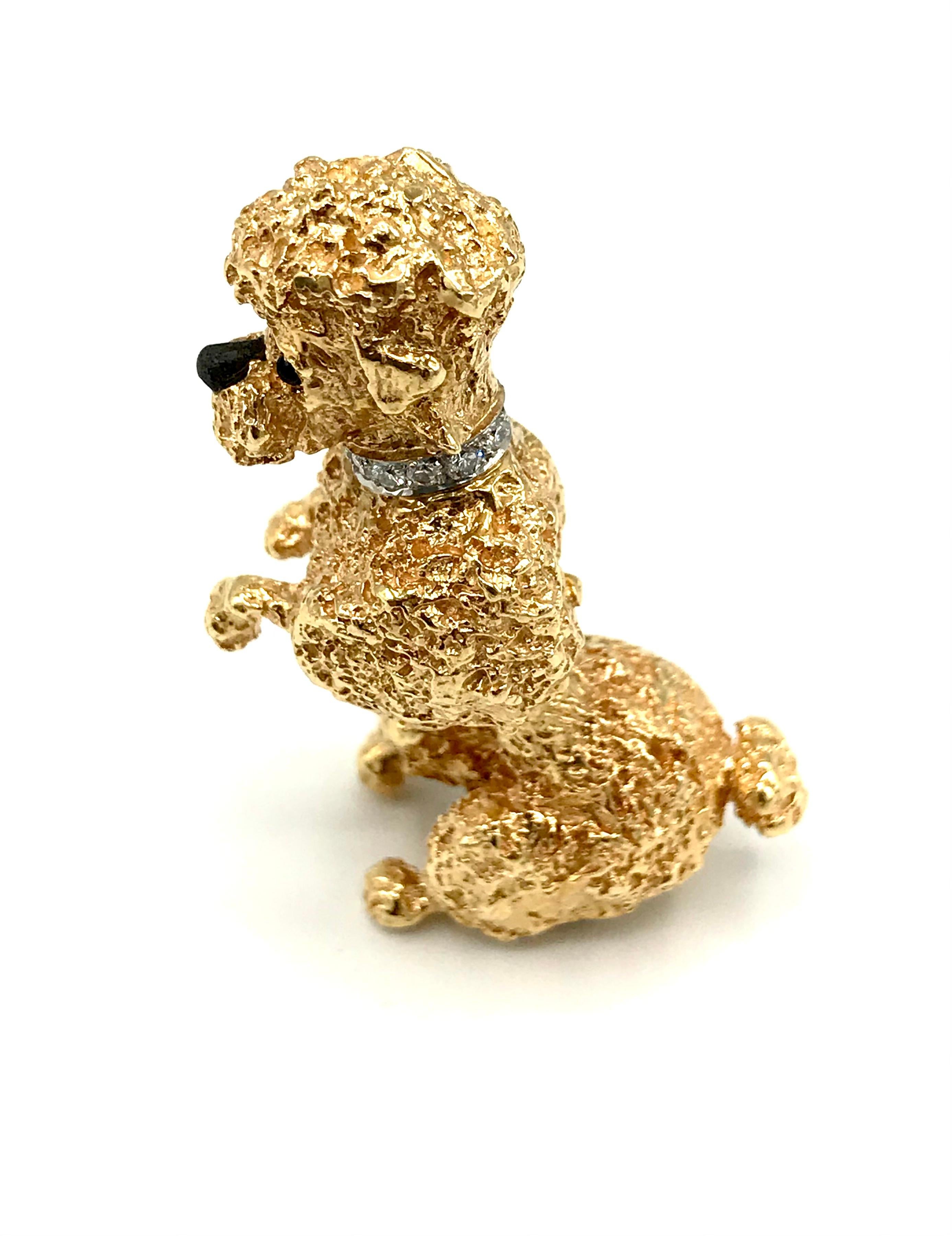 A skillfully crafted vintage Poodle brooch by William Ruser. Features a diamond set collar and onyx eyes. The collar is rhodium plated. Diamonds are round brilliant cut, total carat weight is approximately 0.3 points.  
Stamped with the Ruser