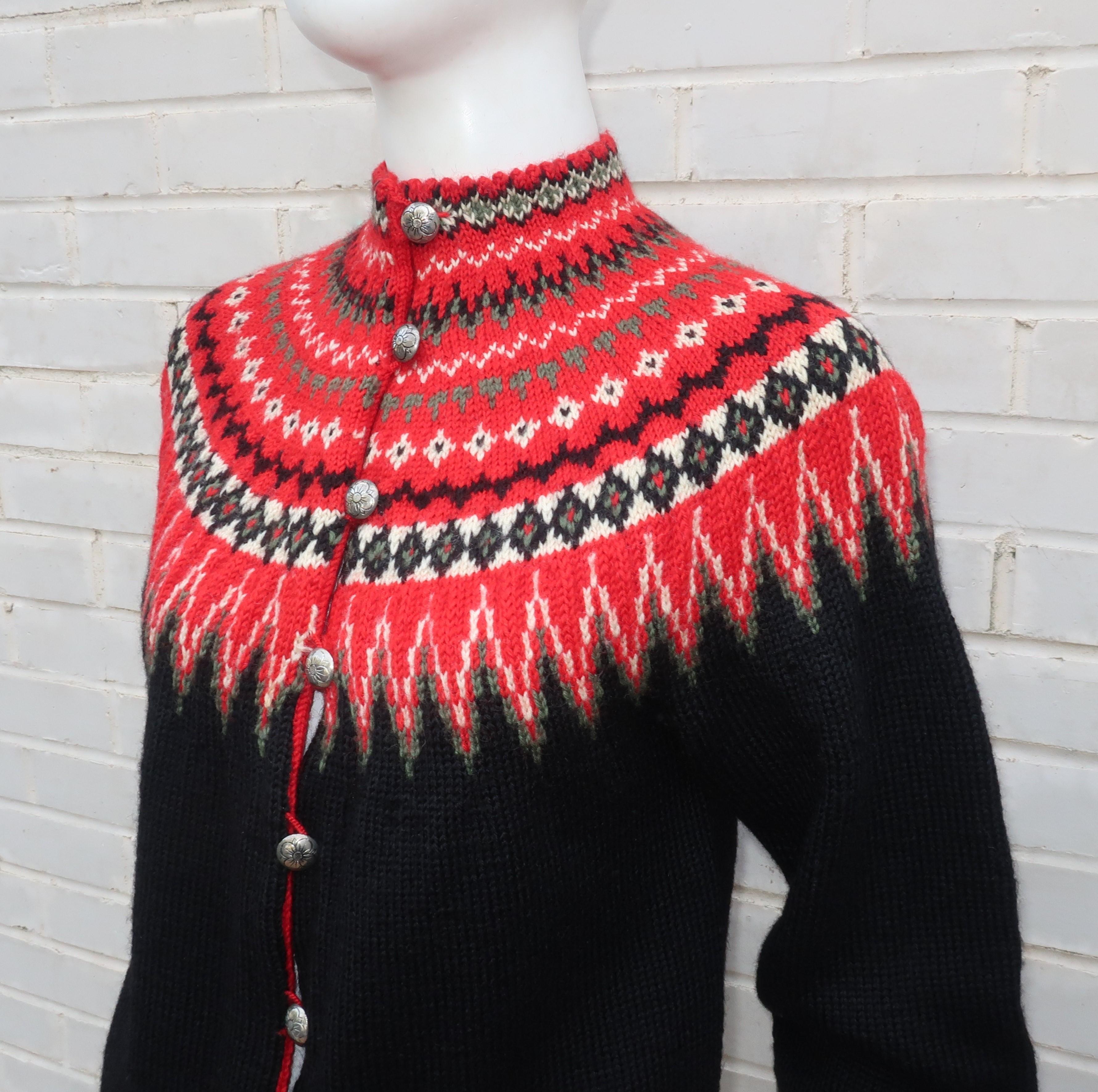 C.1950 fair isle style wool sweater by Norwegian knitwear company, William Schmidt of Oslo.  The intricate red, white and green geometric pattern at the neckline set against a black background creates a subtle trompe l'oeil effect that could almost