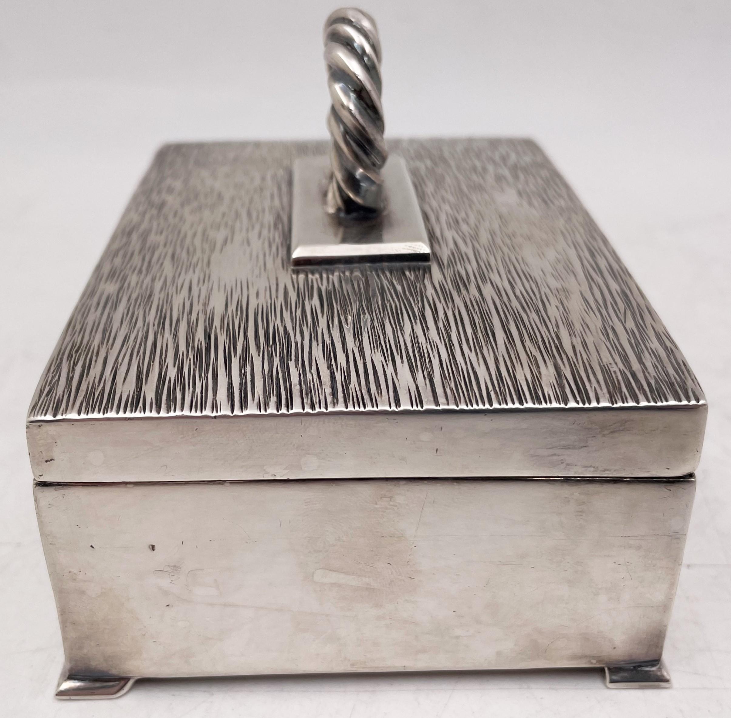 William Seitz sterling silver, handwrought box in Arts & Crafts style, with an engraved cover and a handle in rope style as well with a gilt interior, measuring 4 5/8'' in length by 3 3/8'' in width by 3'' in height, weighing 15.1 troy ounces, and