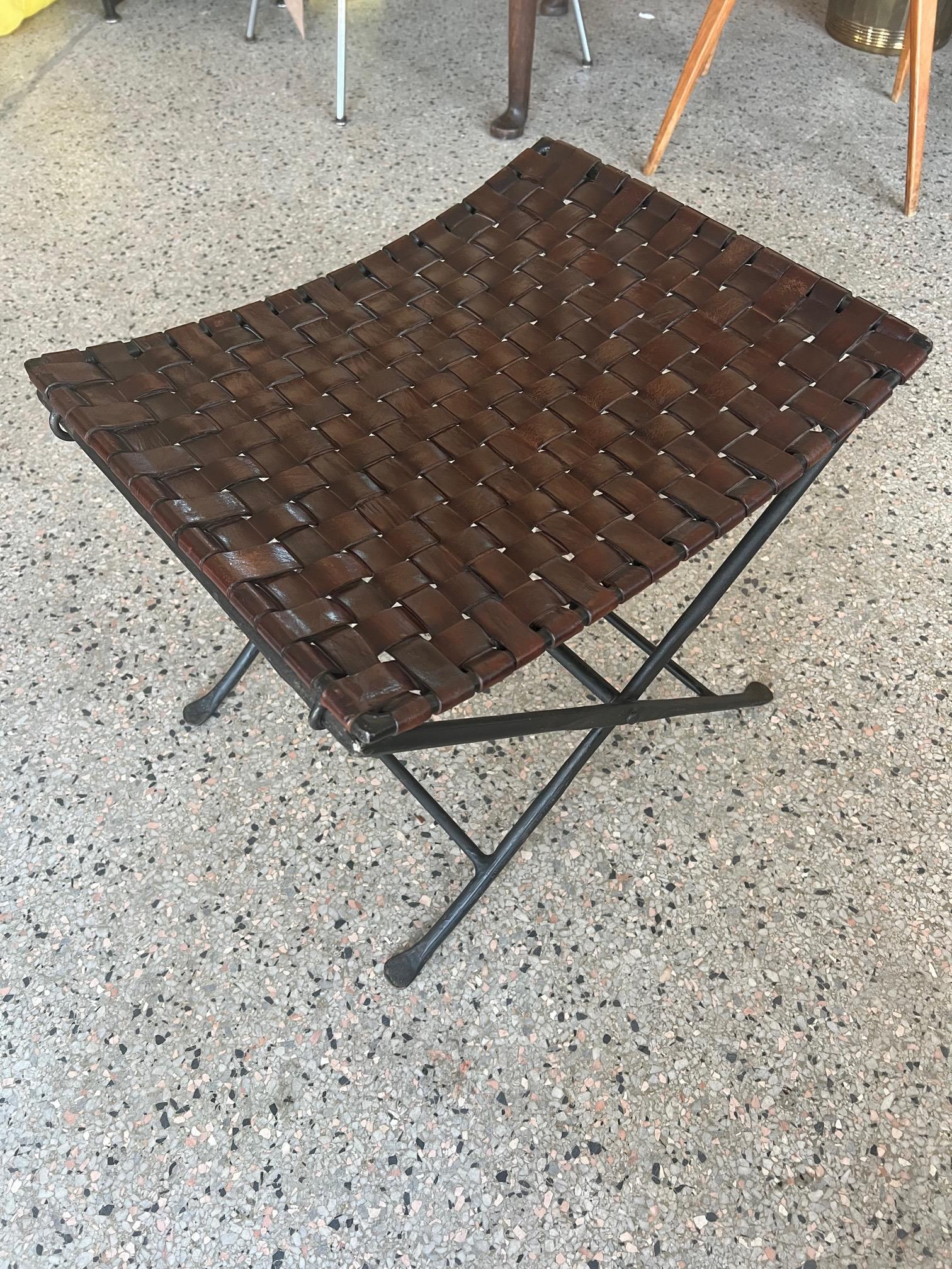 Unusual folding foot stool by William Sheppee. Heavy wrought iron and patinated brown saddle leather.