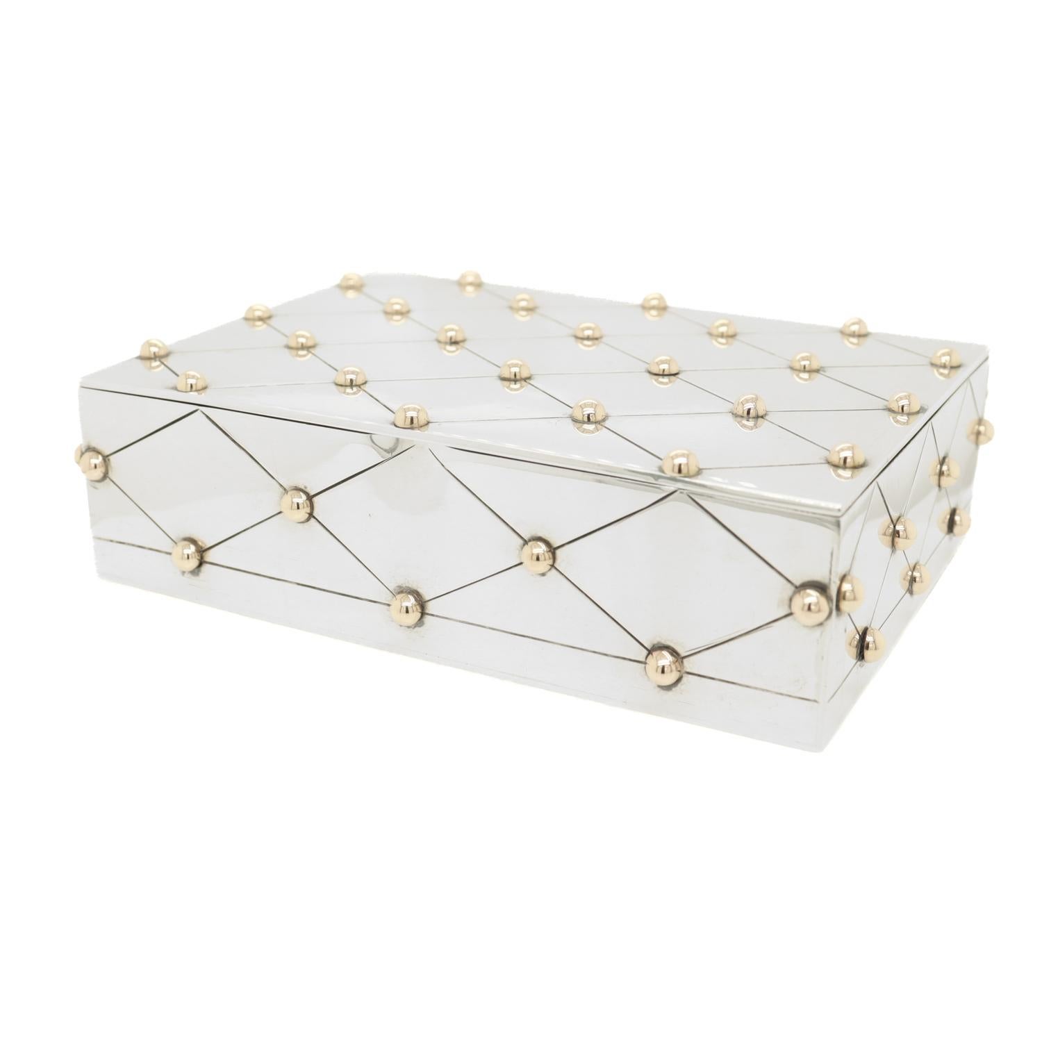 A fine Mexican Modernist table box.

In sterling silver.

By William Spratling.

With a diaper trellis or lattice pattern throughout punctuated with parcel gilt knops or buttons.

Set with a thick gauge lid, a robust hinge to the reverse, and a