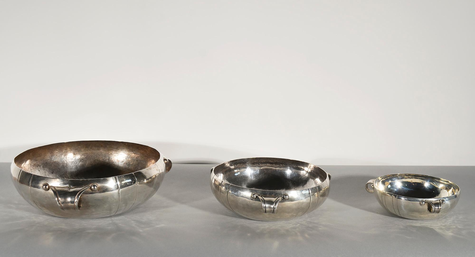 Set of three graduated bowls by silver master, William Spratling. Each bowl has three handles and a linear scored design between the handles.
The smallest of the bowls has an interior diameter of 5 3/4
