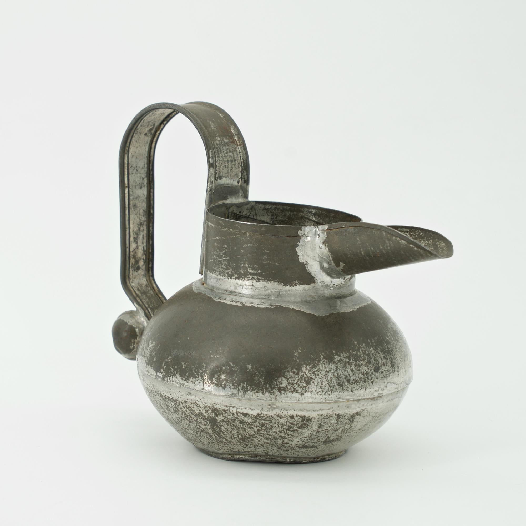 Spratling's early designs were in tin and progressed to silver. Many were prototypes for his later silver designs. Here we have an Etruscan inspired small cream pitcher, impressed TAXCO, and Spratling's WS initials.