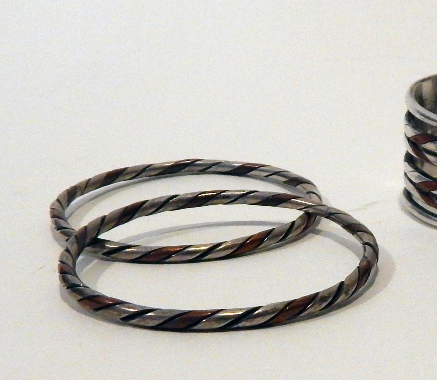 William Spratling, Taxco, Mexico, circa 1940s copper and sterling bangle bracelet set 
The set includes 2 unmarked bangles by Spratling that measure 2 3/4