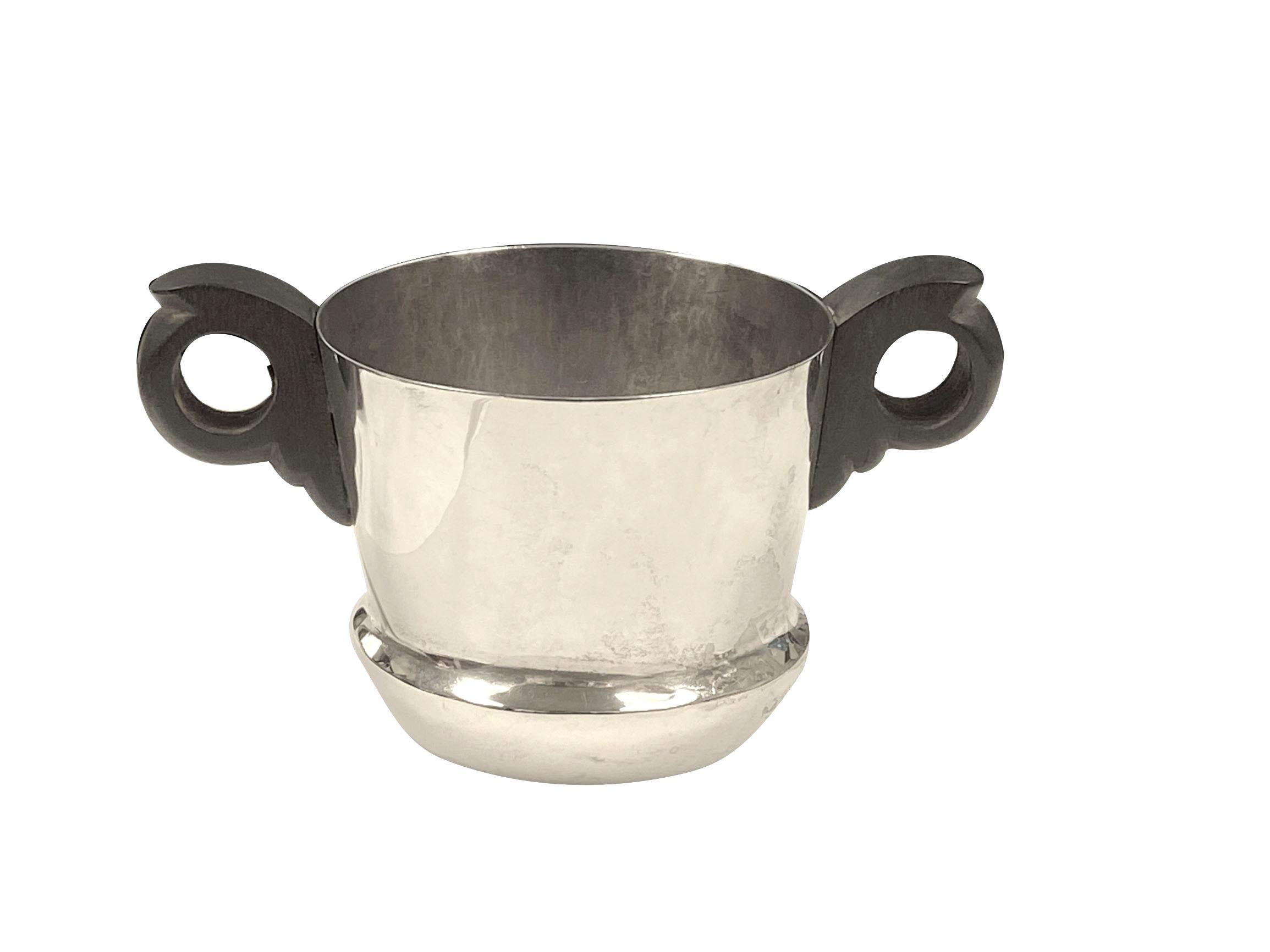 Circa 1950 William Spratling Sterling Silver and wood mounted Creamer and Sugar set, each piece measures 3 inches in height and 3 1/2 inches in diameter and the set weighs 14.6 ounces. 