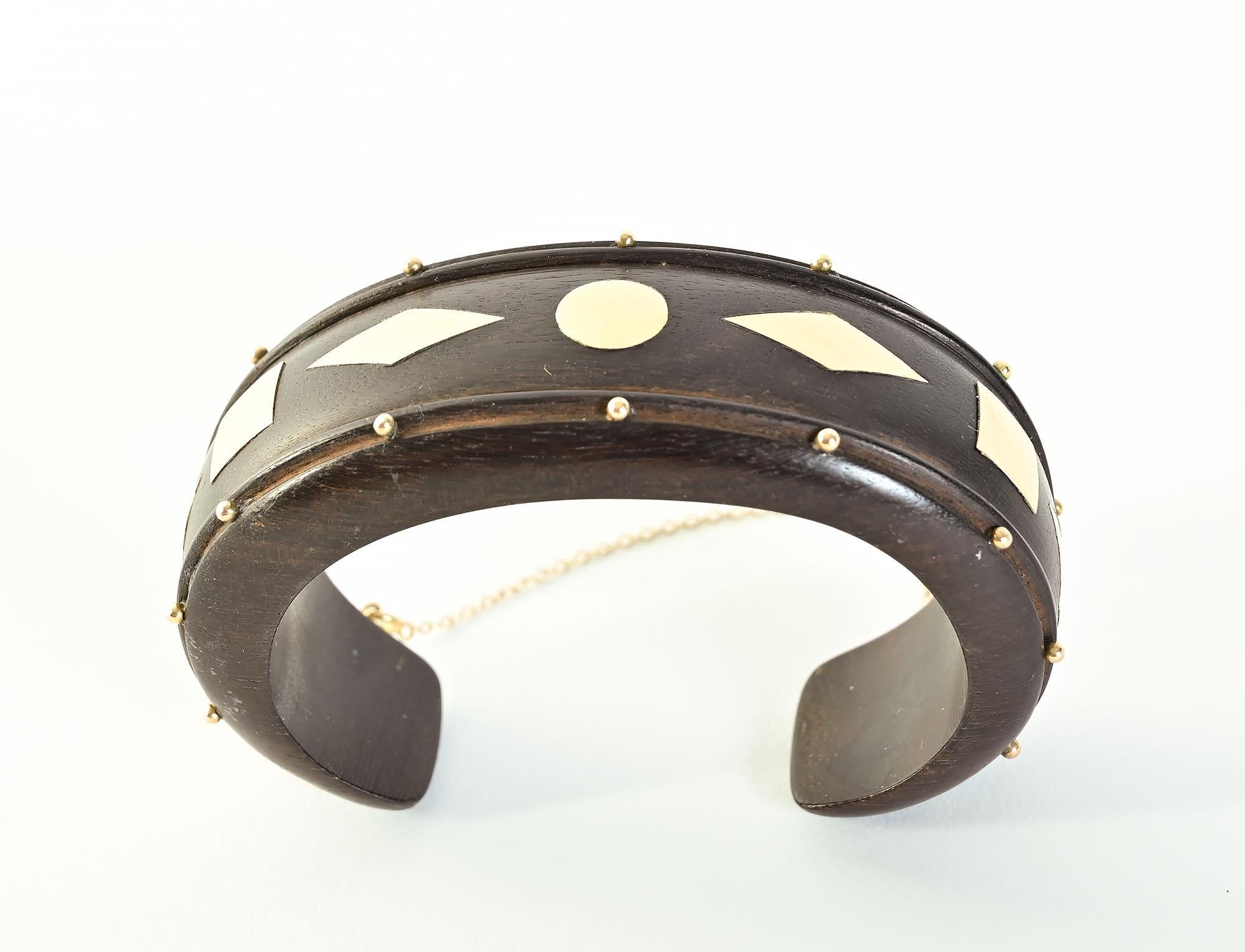 William Spratling is best known for his work with silver. On rare occasions, he also used gold. This stunning and most unusual wood cuff bracelet is embellished with a pattern of diamonds; dots and squares in 18 karat gold. The front of the bracelet