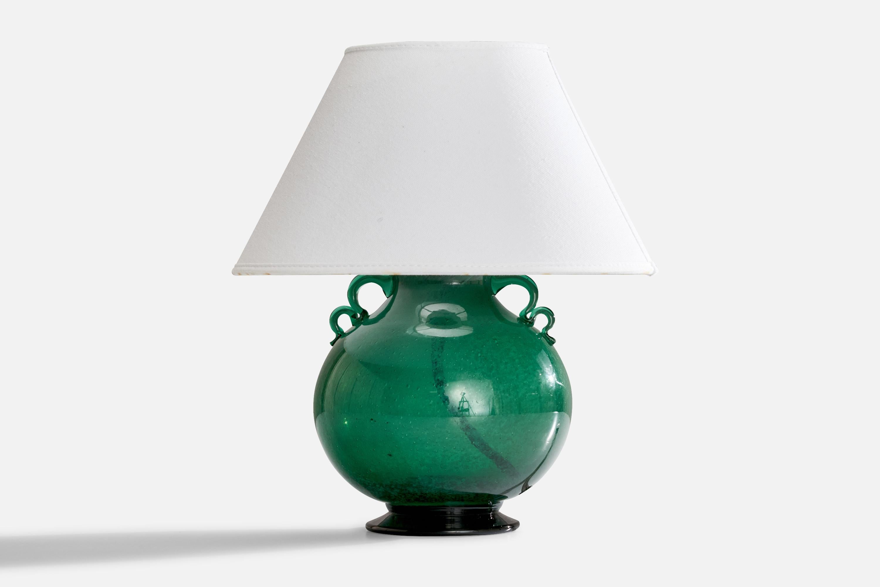 A green glass table lamp designed by WIlliam Stenberg and produced by Gulaskruf Glasbruk, Sweden, c. 1940s.

Dimensions of Lamp (inches): 8.125” H x 5.25” W x 5.75” D
Dimensions of Shade (inches): 4.75” Top Diameter x 9.875” Bottom Diameter x 5.875”