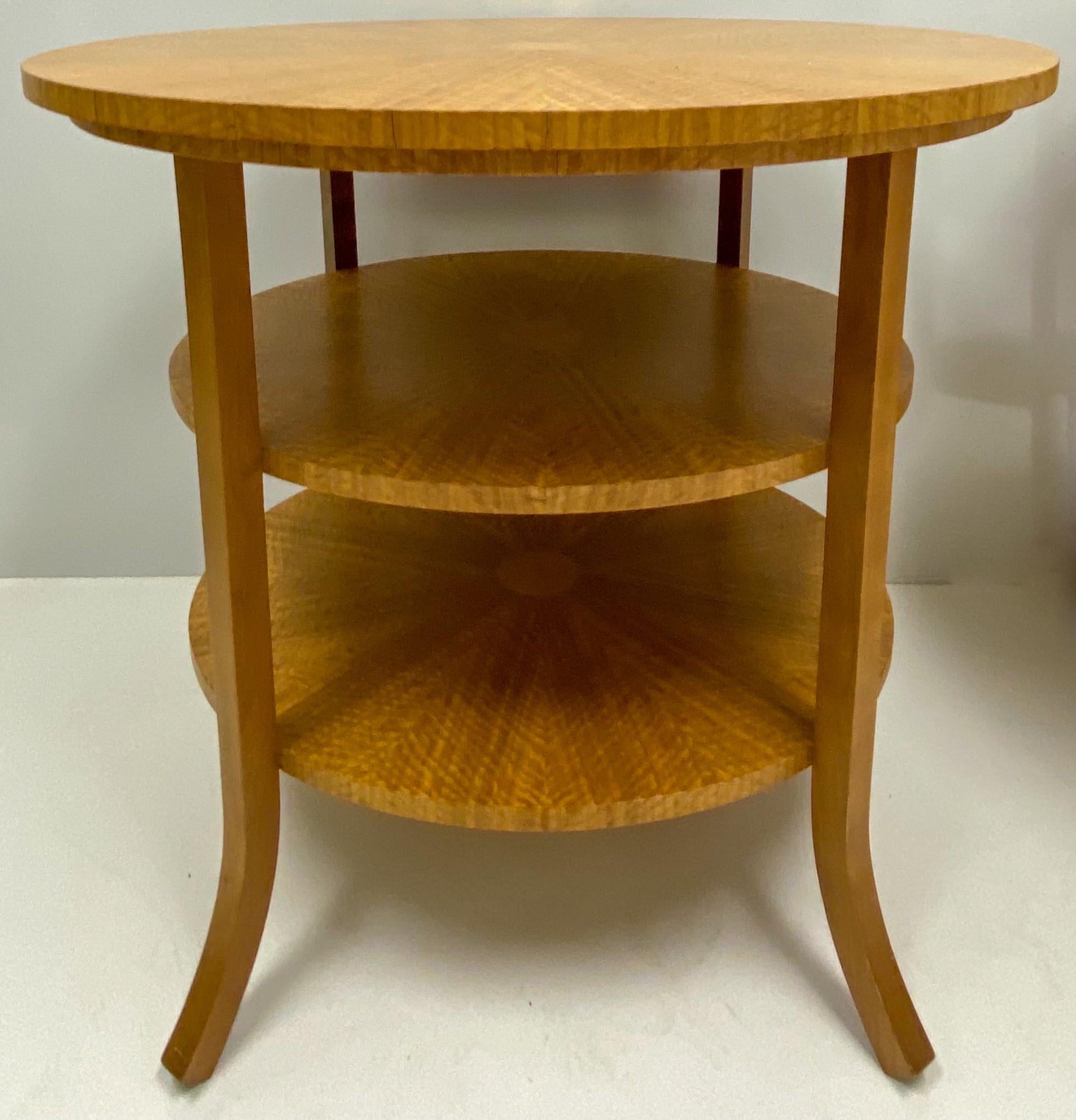 This is a pair of late 20th century William Switzer satinwood multi-tiered side tables. They are marked and in very good condition.