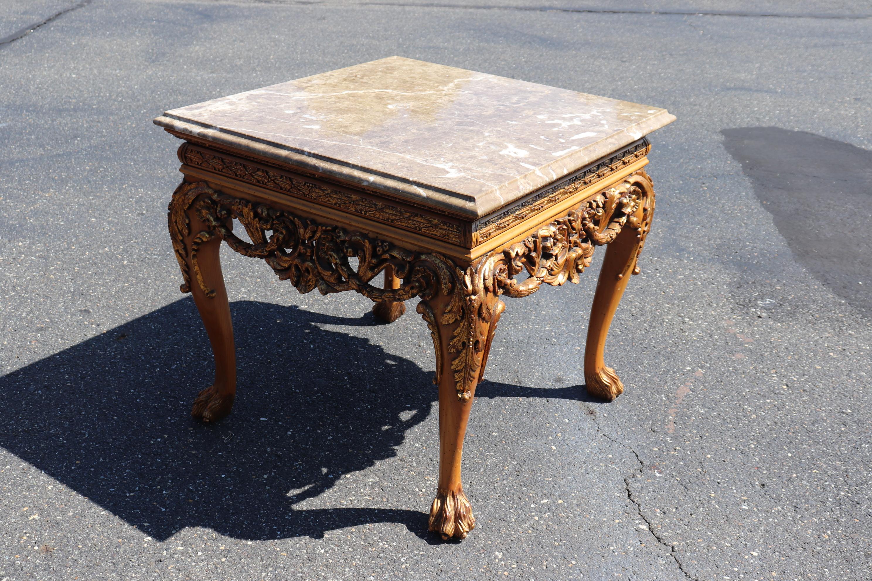 This is a fantastic William Switzer table made of solid oine with gilt wood highlights, The top is a beautiful piece of marble and the table was made in Europe. The table measures 33 wide x 33 deep x 31 tall. The table dates to the 2000s era and