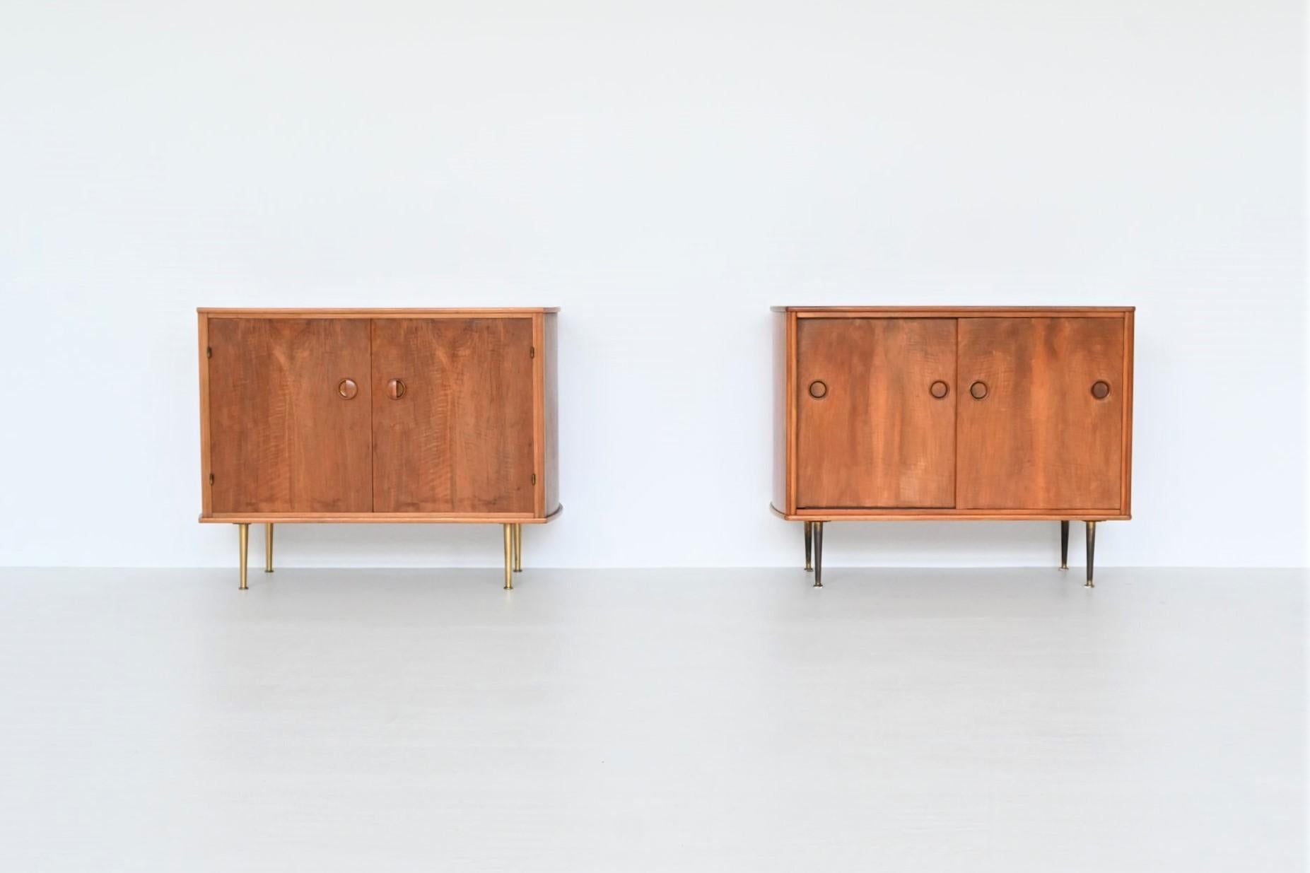 Beautiful pair of cabinets designed by William Watting and manufactured by Fristho Franeker, The Netherlands 1960. These nicely refined cabinets are made of high quality walnut wood and have a beautiful warm grain to the veneer. One has two sliding