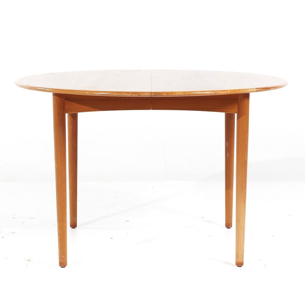 William Watting Style Mid Century Danish Teak Expanding Dining Table with 2 Leaves

This table measures: 45.25 wide x 45.25 deep x 28.25 inches high, with a chair clearance of 27.5 inches, each leaf measures 19.75 inches wide, making a maximum table