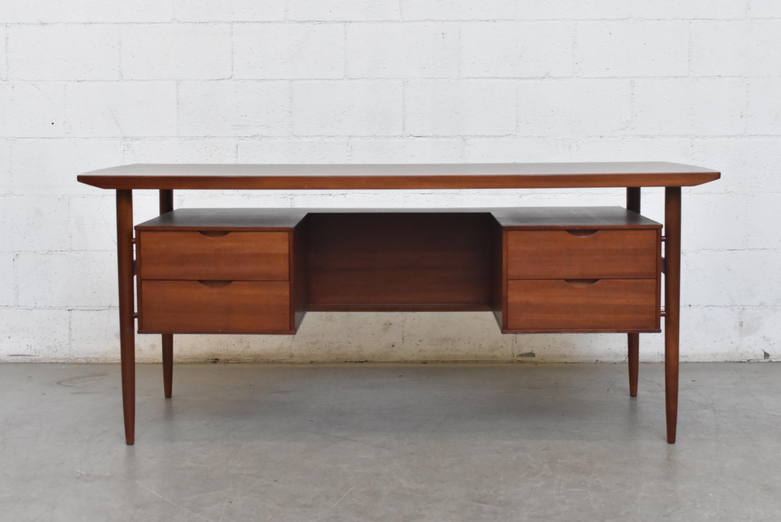 William Watting style midcentury teak desk, lightly refinished with floating top with back book case as privacy screen tapered legs. Good original condition with some wear consistent with its age and usage.