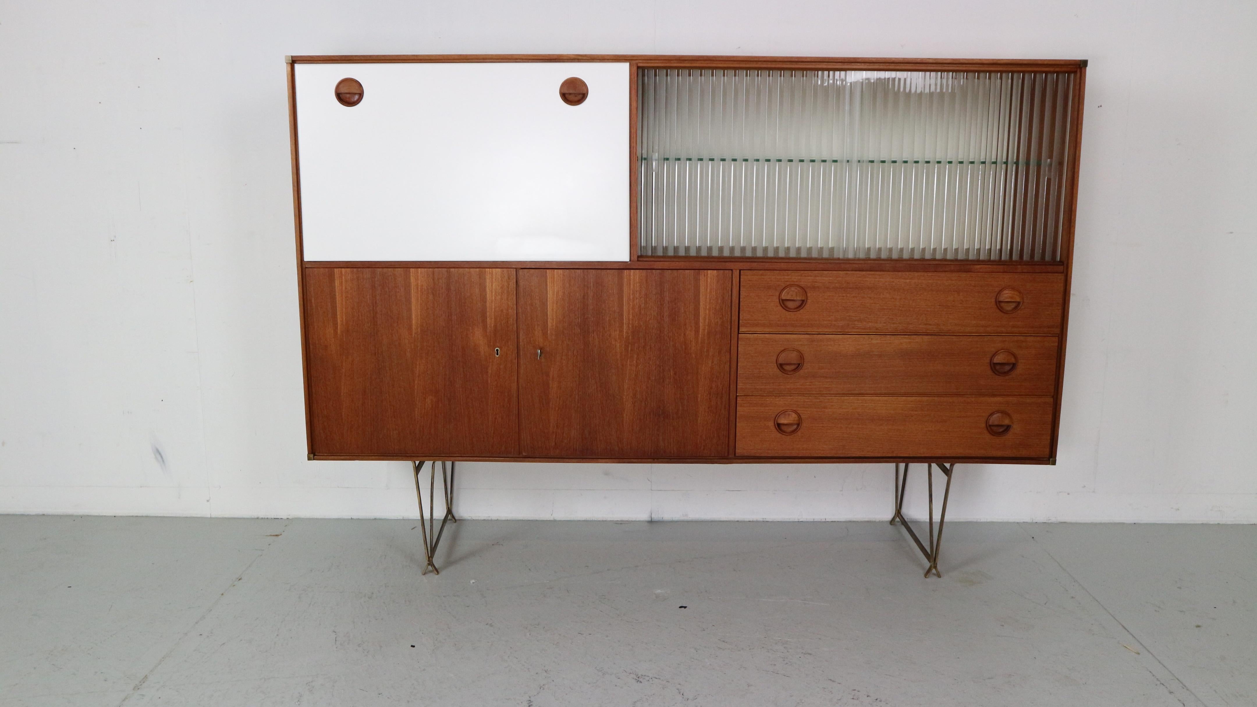 Mid- Century modern period high-board or other words buffet cabinet designed by William Watting and manufactured for Fristho in 1950's period, The Netherlands.

Originally marked.

Cabinet is made of teak wood with white lacquered buffet clapping