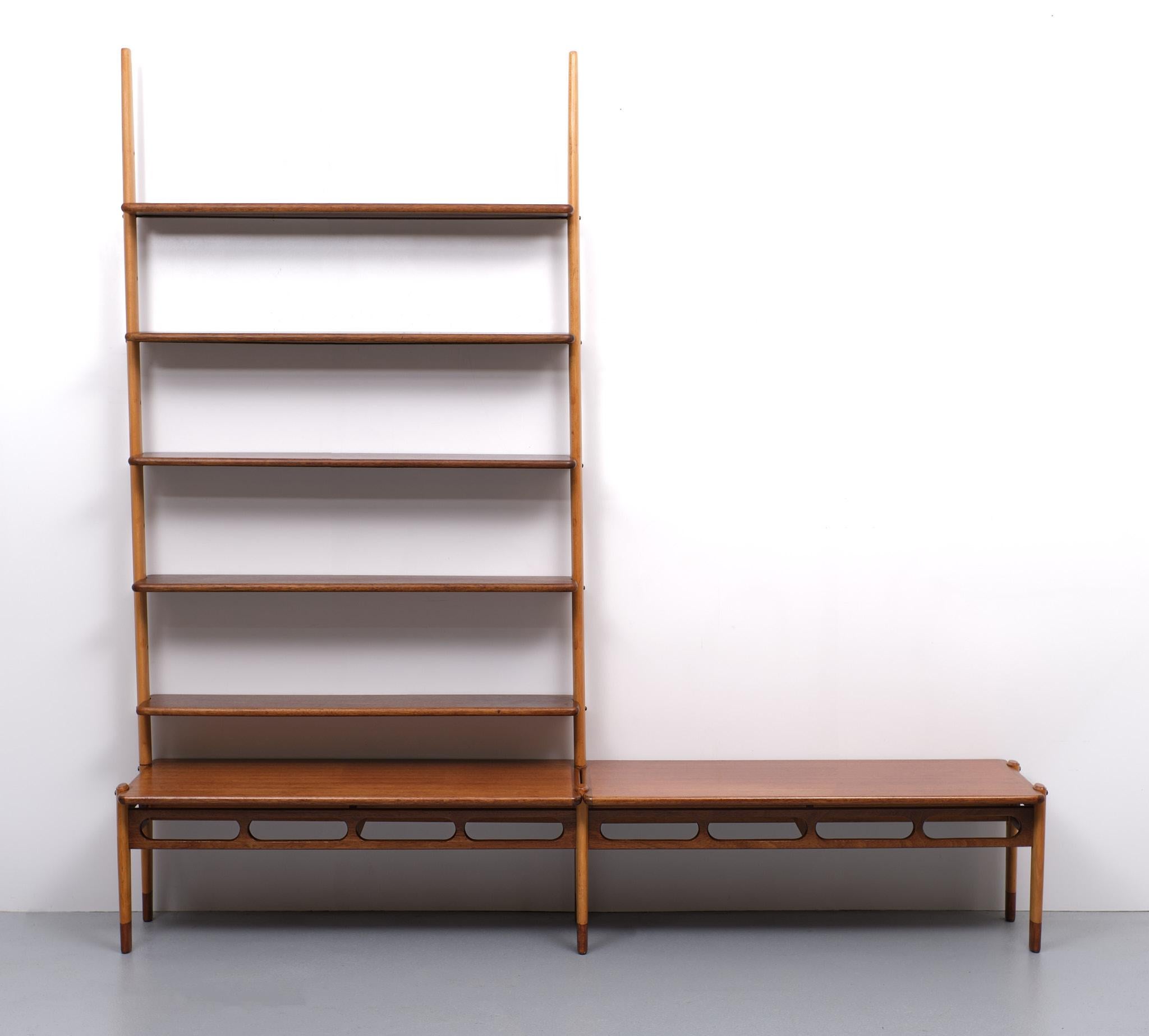 Beautiful modular two-tone wall unit designed by William Watting for Fristho, This open storage unit is made of solid teak shelves and solid beech uprights. . features an ingenious system for attaching the shelves to the risers. The shelves can be