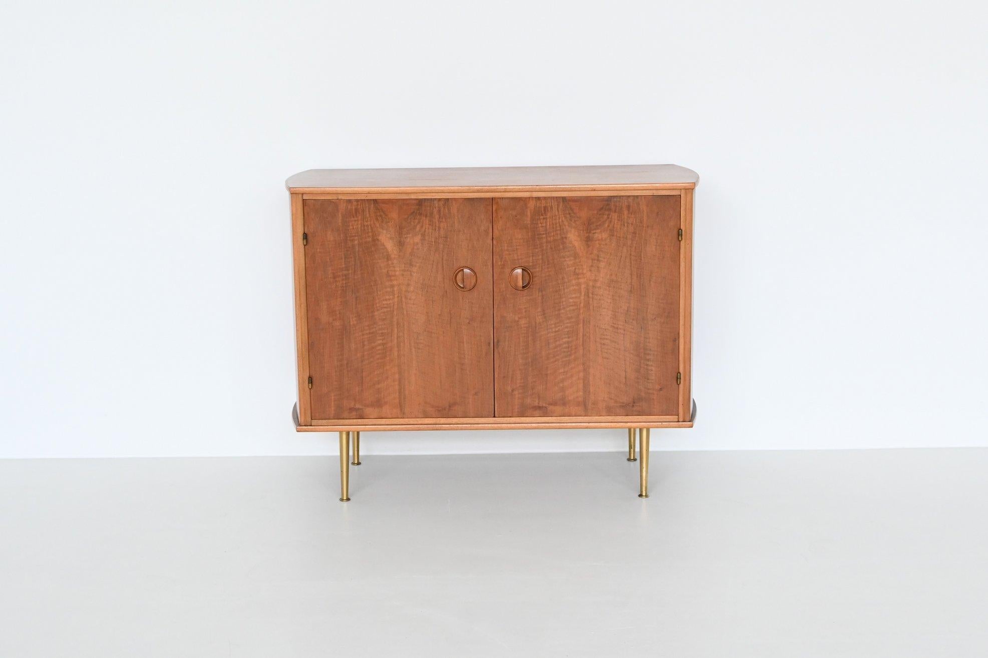 Beautiful cabinet designed by William Watting and manufactured by Fristho Franeker, The Netherlands 1960. This nicely refined cabinet is made of high quality walnut wood and has a beautiful warm grain to the veneer. It has two doors with a wide