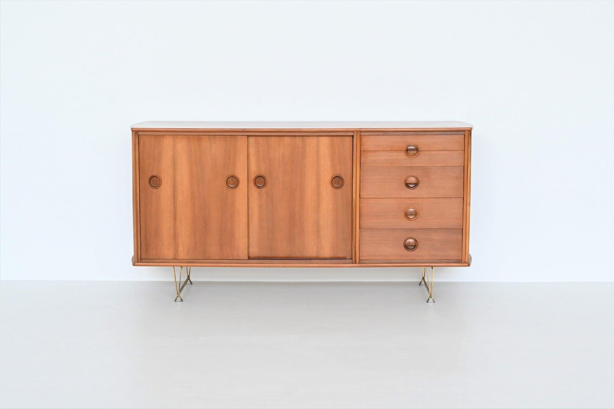 Beautiful sideboard designed by William Watting and manufactured by Fristho Franeker, The Netherlands 1960. This nicely refined cabinet is made of high quality walnut wood and has a beautiful warm grain to the veneer. It has two sliding doors with
