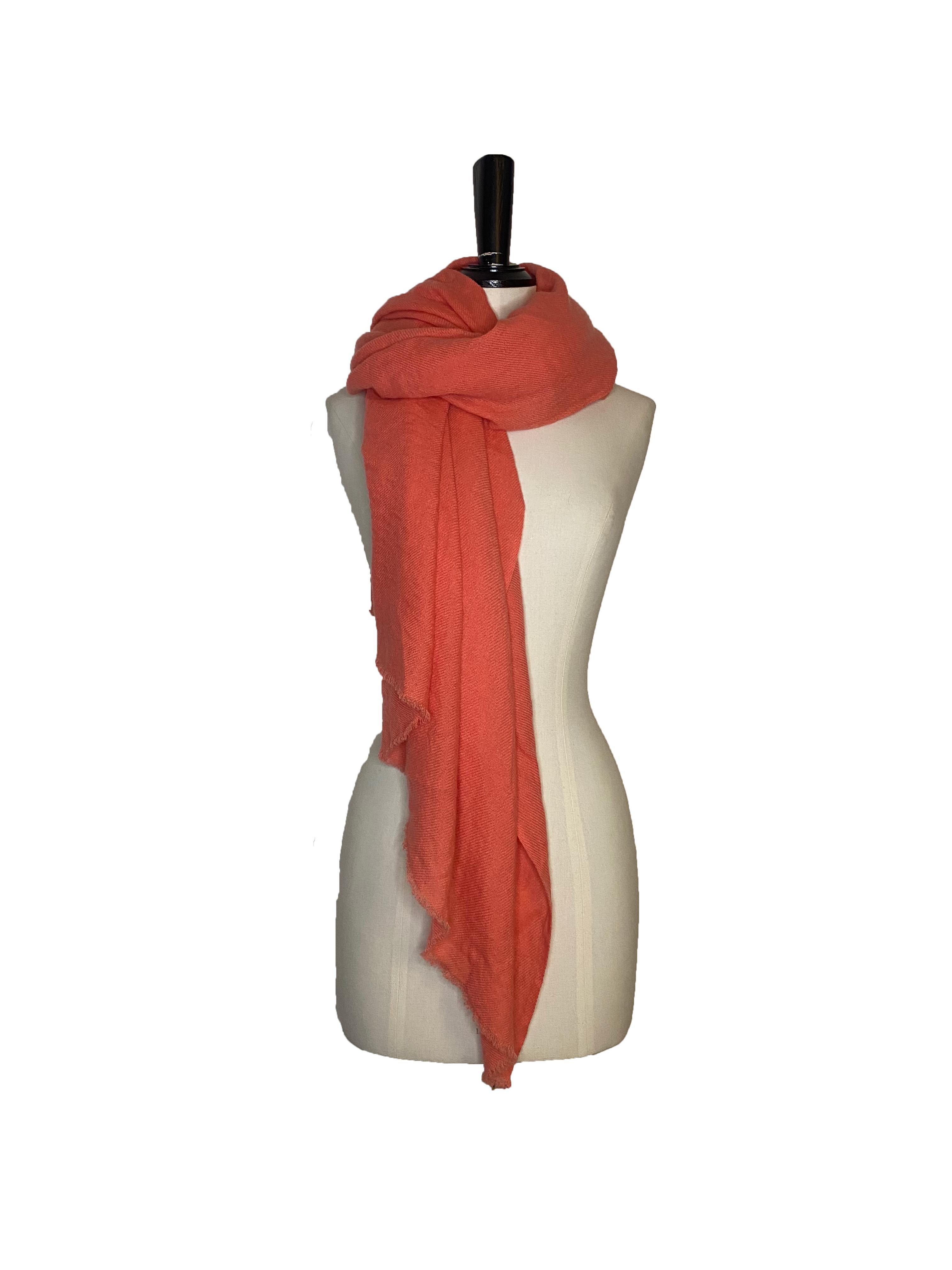 Cashmere stole from William Welstead for Comme des Garcons. Coral cashmere with short fringing around the edges. Fabric content: 100% cashmere. Dimensions: 100cm x 190cm. Excellent condition, brand new with tags. Retails at £805.