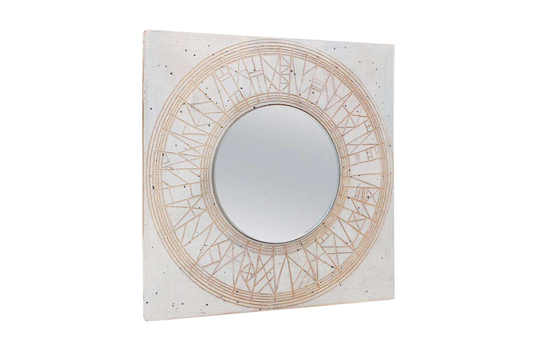 Square Studio Pottery mirror by Massachusetts potter William Wyman. This mirror is uniquely carved in a geometric design. Signed and dated with the Wyman script to reverse.

____

We're offering our customers free domestic shipping on all items