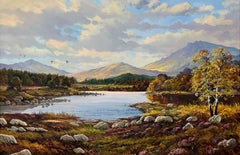 A tranquil mountain lake scene with vivid light, colour and natural beauty