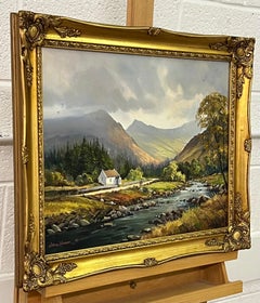 Figures by a River Cottage in the Irish Mountain Landscape with Lush Green Trees