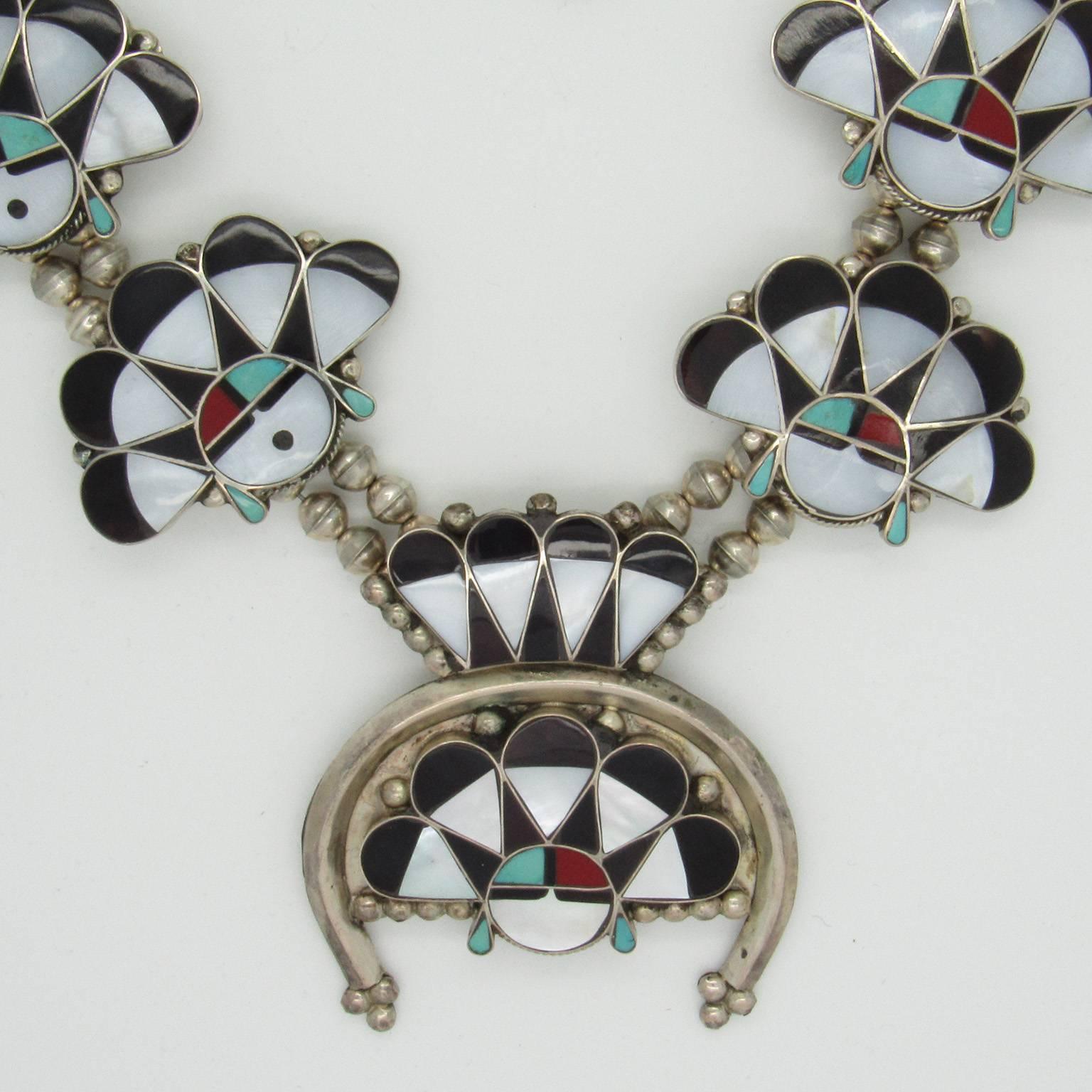 William Zunie, Sunface, necklace, circa 1970.  Inlaid with turquoise, jet, mother of pearl and red coral, the necklace consists of a pendant (naja) and eight smaller sunfaces on a beaded double strand.  Signed 