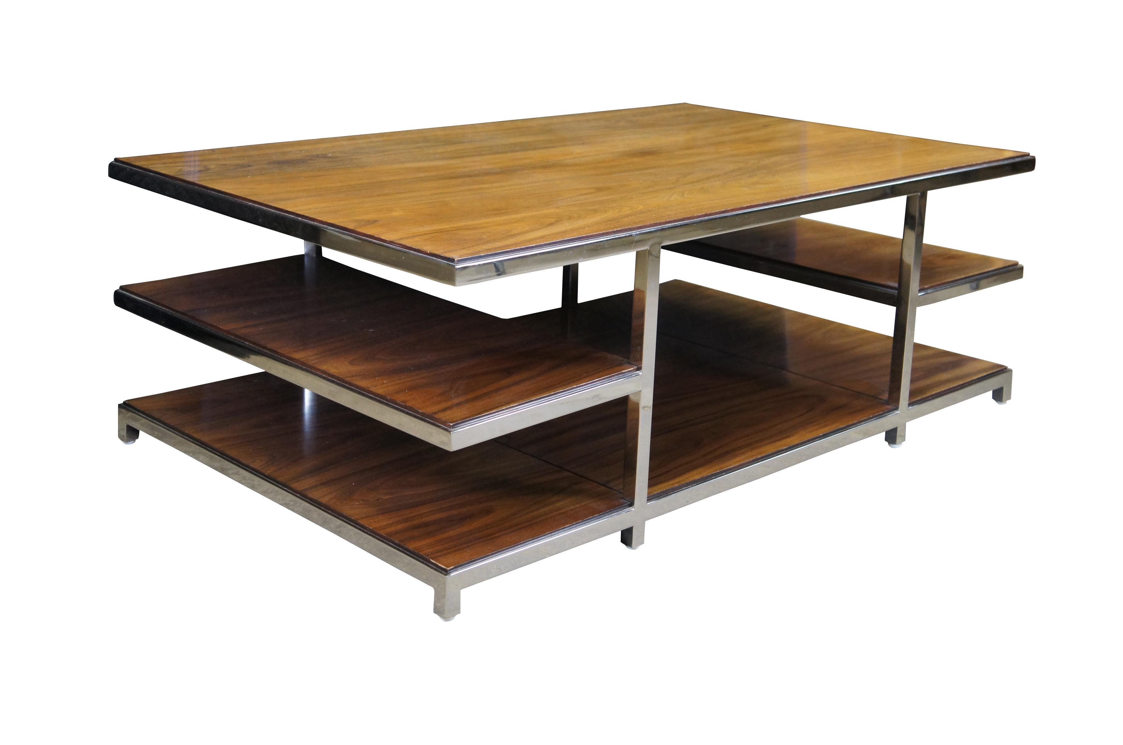Williams Sonoma Home Tribeca Coffee Table. Sturdy stainless-steel chrome finished frame features seamless welding for a sleek, uniform appearance. A rosewood surface and tiered shelves create an open, airy look . Enables artful organization of