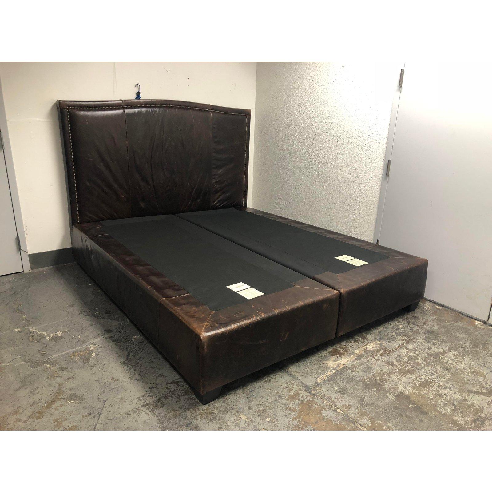 This is a Sutton California king bed frame from the Williams Sonoma home collection. The leather is well worn, adding visible conditions to the distressed style. Severely distressed brown leather, brass pinhead trim, and cal king size make this