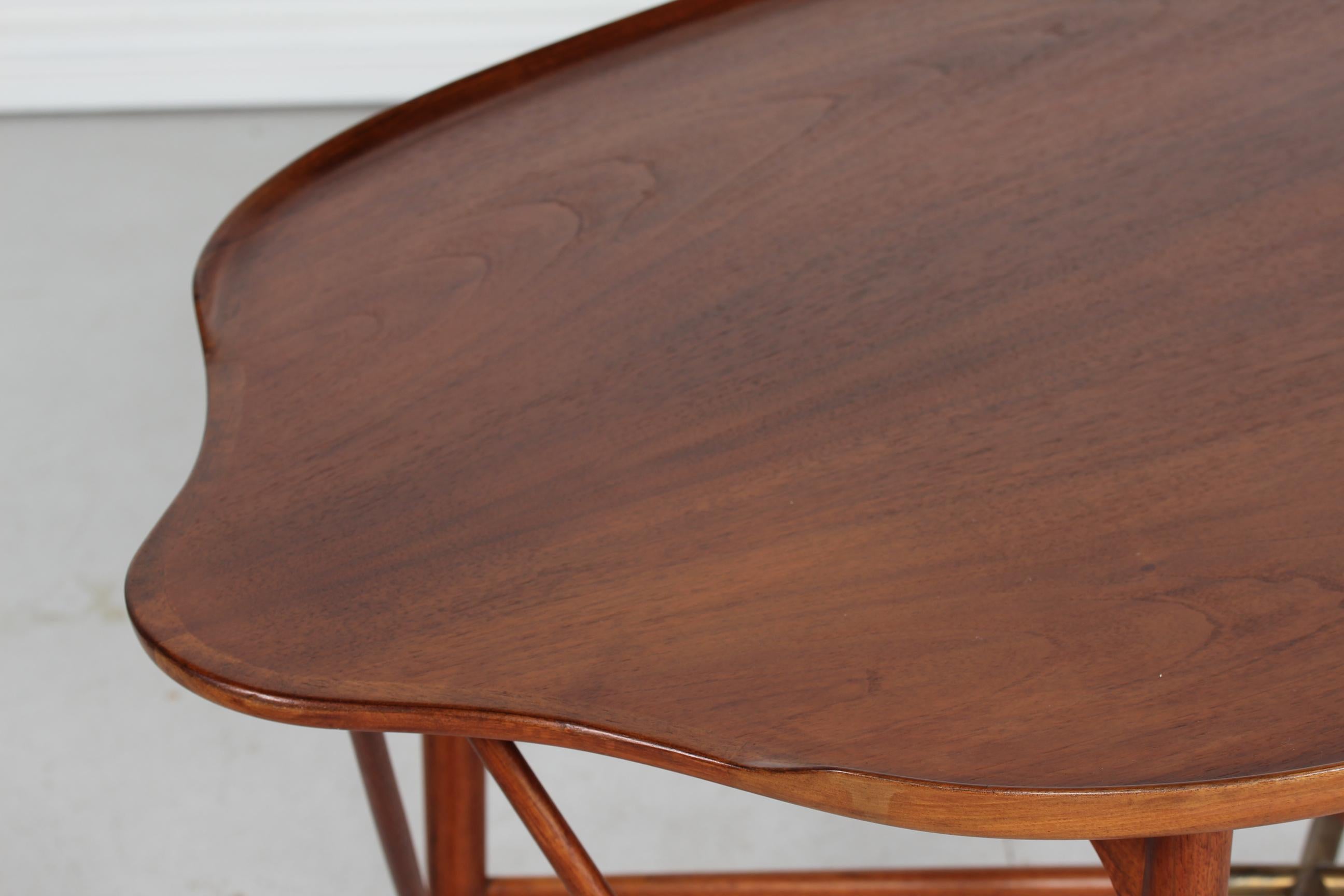 Willian Watting organically shaped coffee table manufactured by Mikael Laursen in 1950´s.
The table is made of walnut with lacquer and the rim is raised along the long sides. The tip of the four table legs are covered with brass.


 