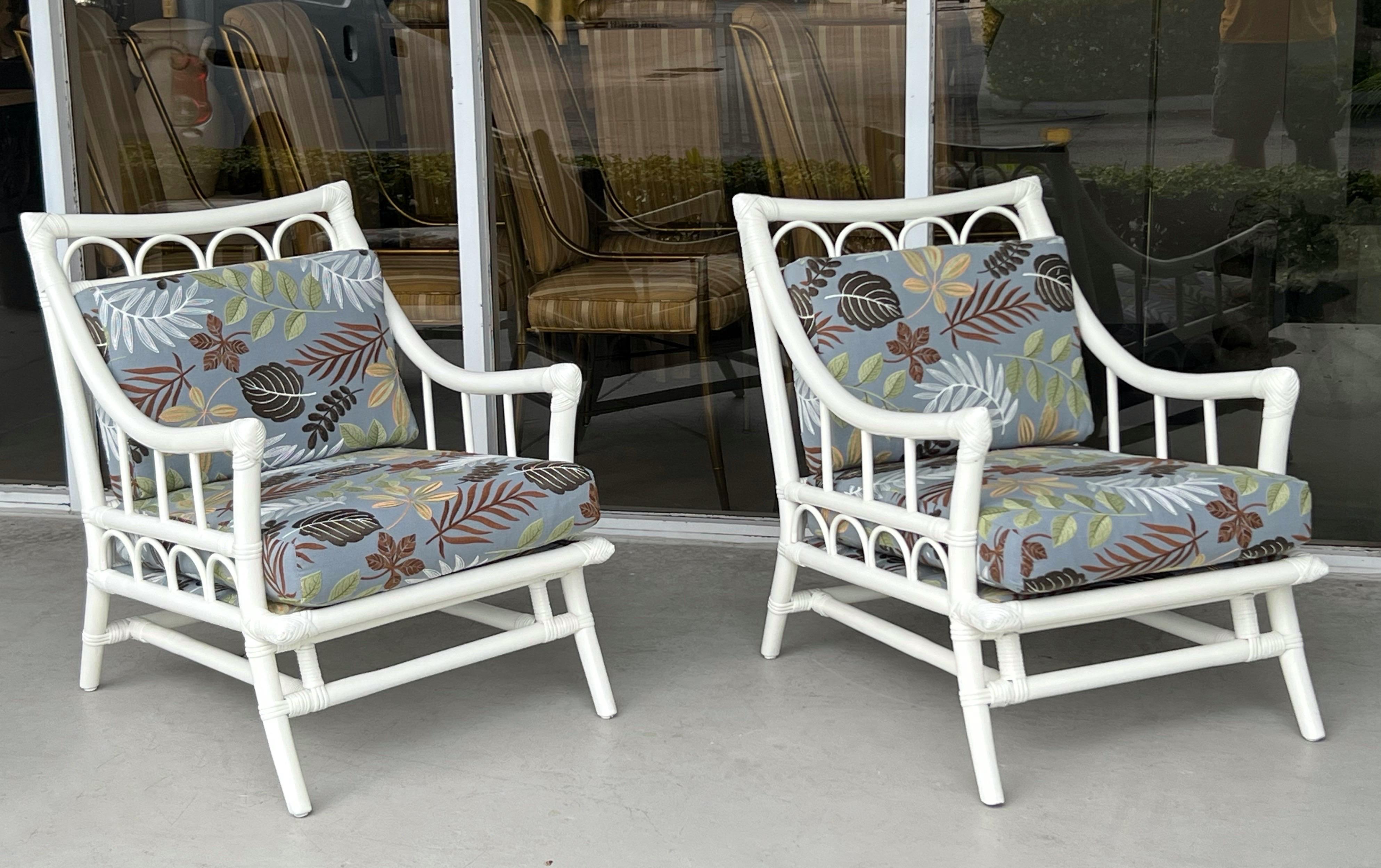A pair of rattan lounge chairs by Willow and Reed. New upholstery has the leaves embroidered. 