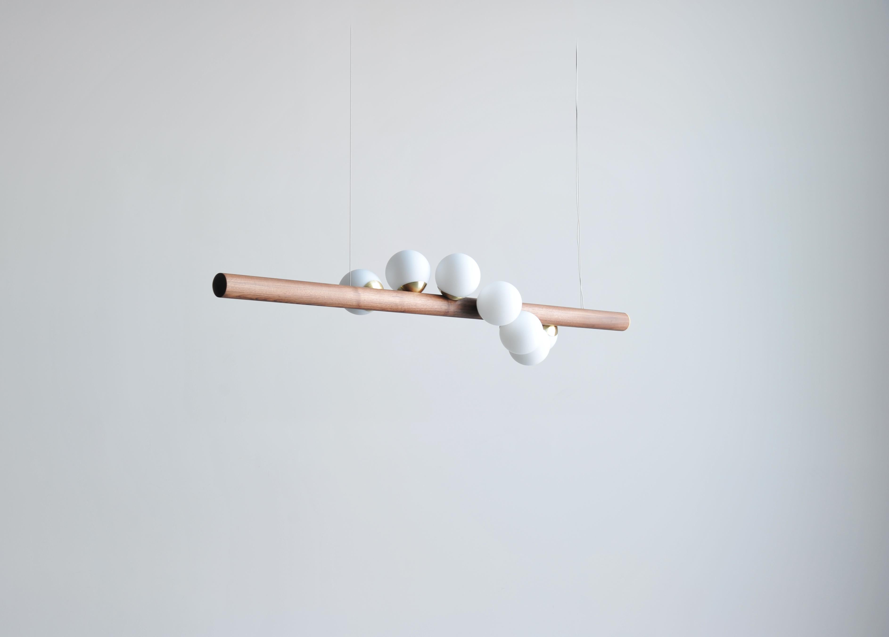 Willow horizontal pendant light by Hollis & Morris
2019
Dimensions: 5ft -length 60” x diameter 2.25” 
Materials: Solid wood, spun brass, hand blown glass

Options available:
Wood: W. oak white, w. oak natural, w. oak black, walnut
3ft - 36”