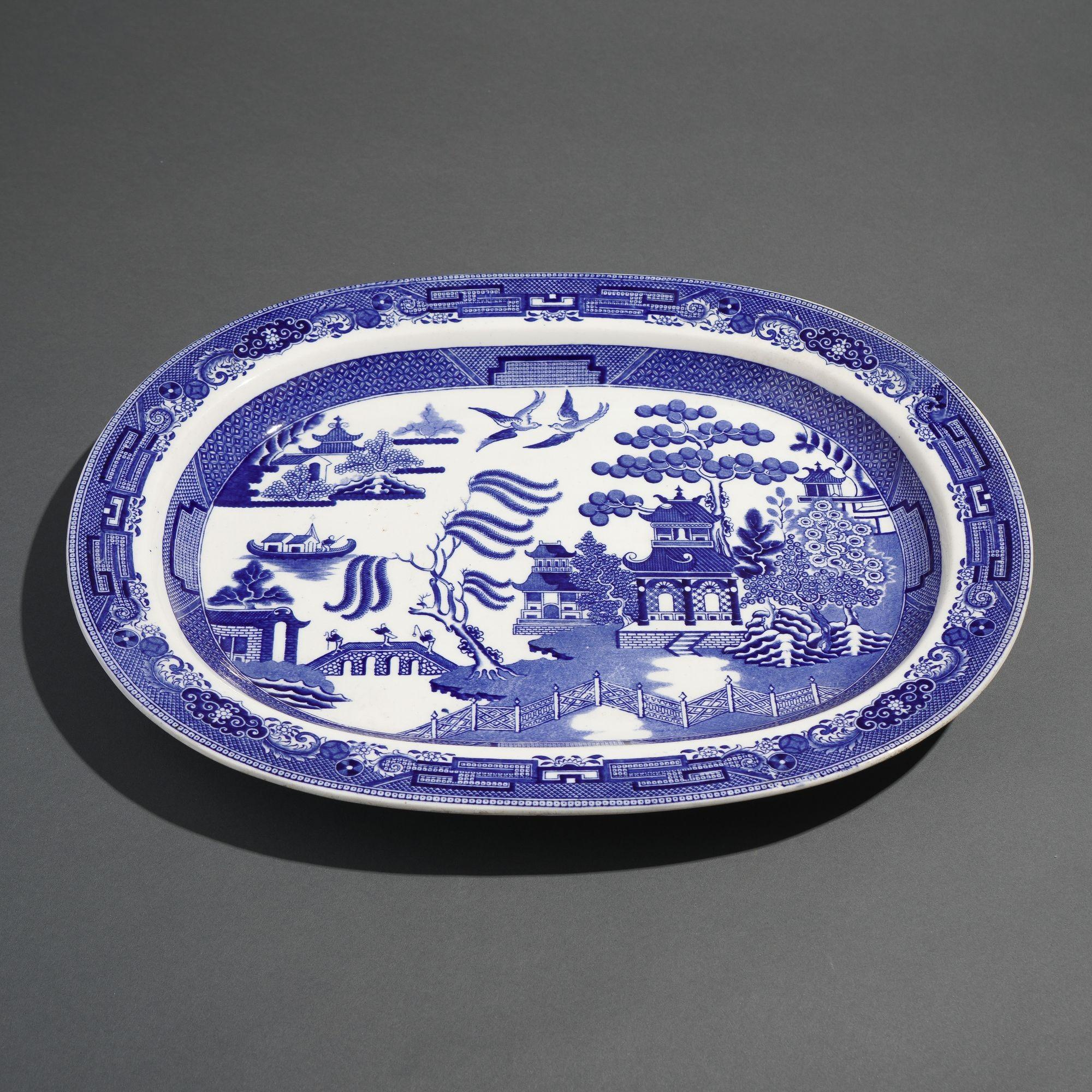 Staffordshire oval platter decorated in the Willow transfer pattern, after a Chinese model.

Stamped on the underside: Wedgwood, 3EO, T (which indicates the manufacturing years of 1891-92)
Marked in the glaze on the underside: