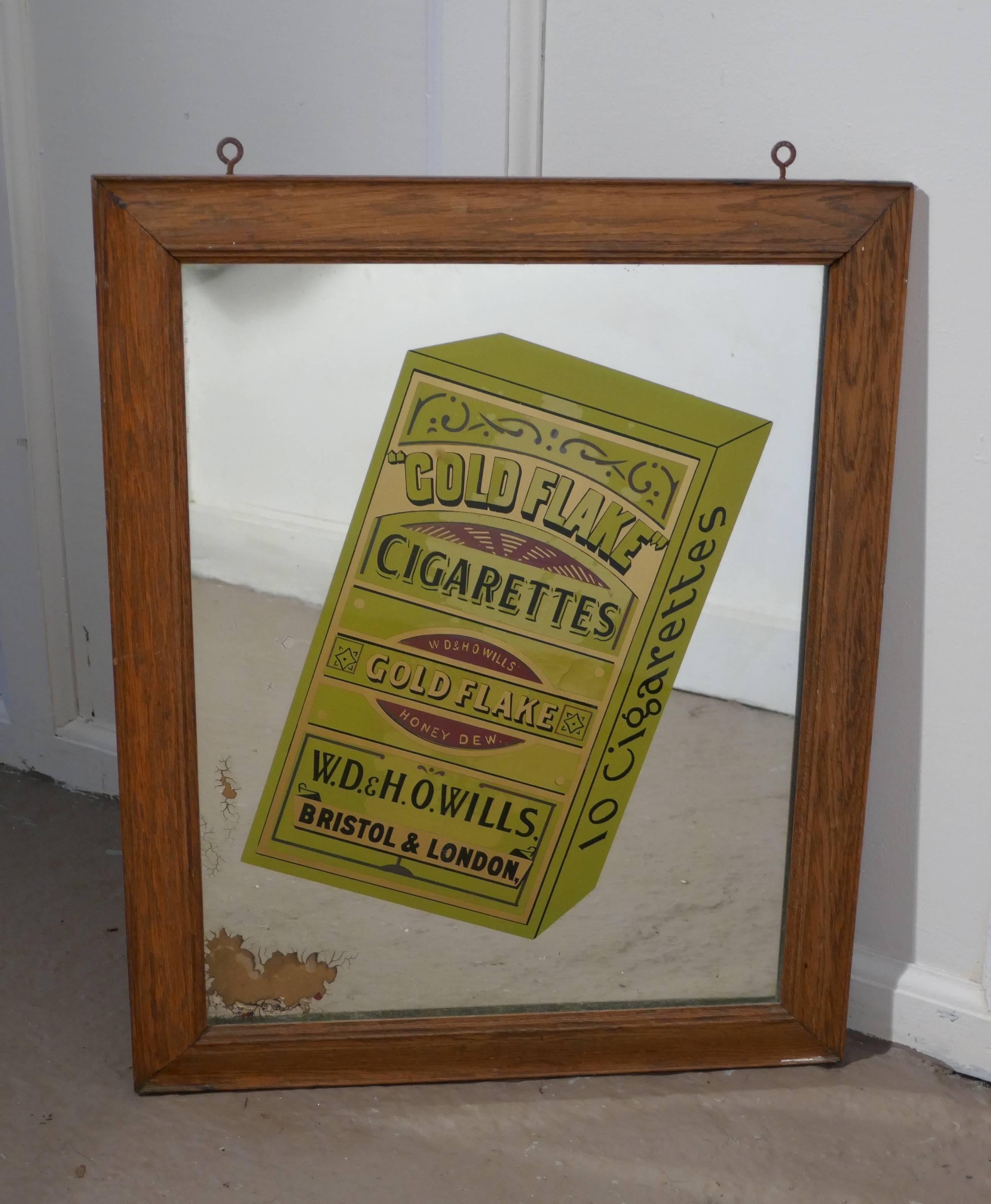 Wills Gold Flake cigarettes advertising mirror

Very rare old mirror, a bold picture of the Gold Flake packet set in an golden oak frame
The main body of the mirror is in good general condition sadly there is a patch in one corner where the