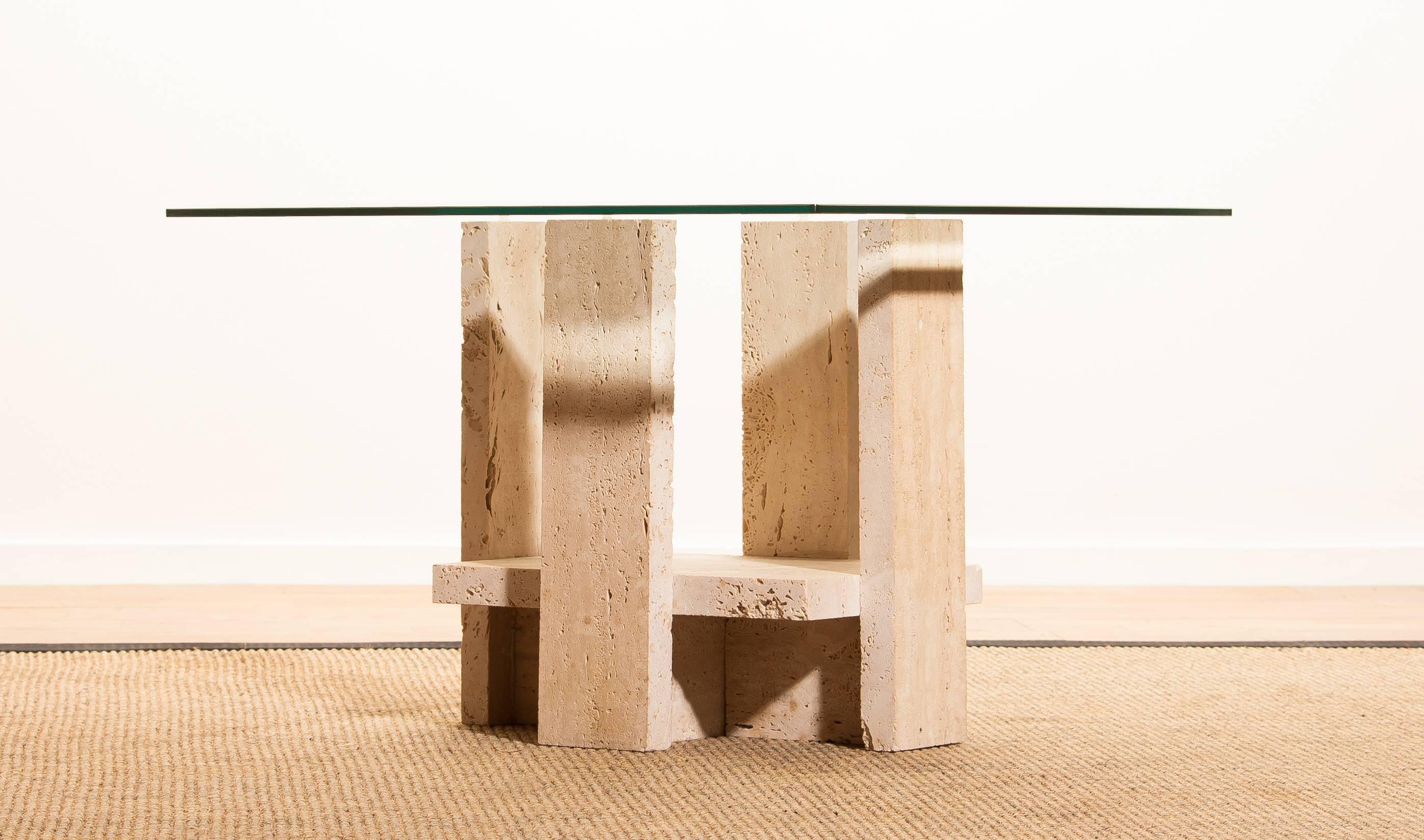 Lovely coffee table by Willy Ballez, circa 1970. This unique piece has a high quality, sculptural travertine base with a faset cut edge square glass top. In good original condition.