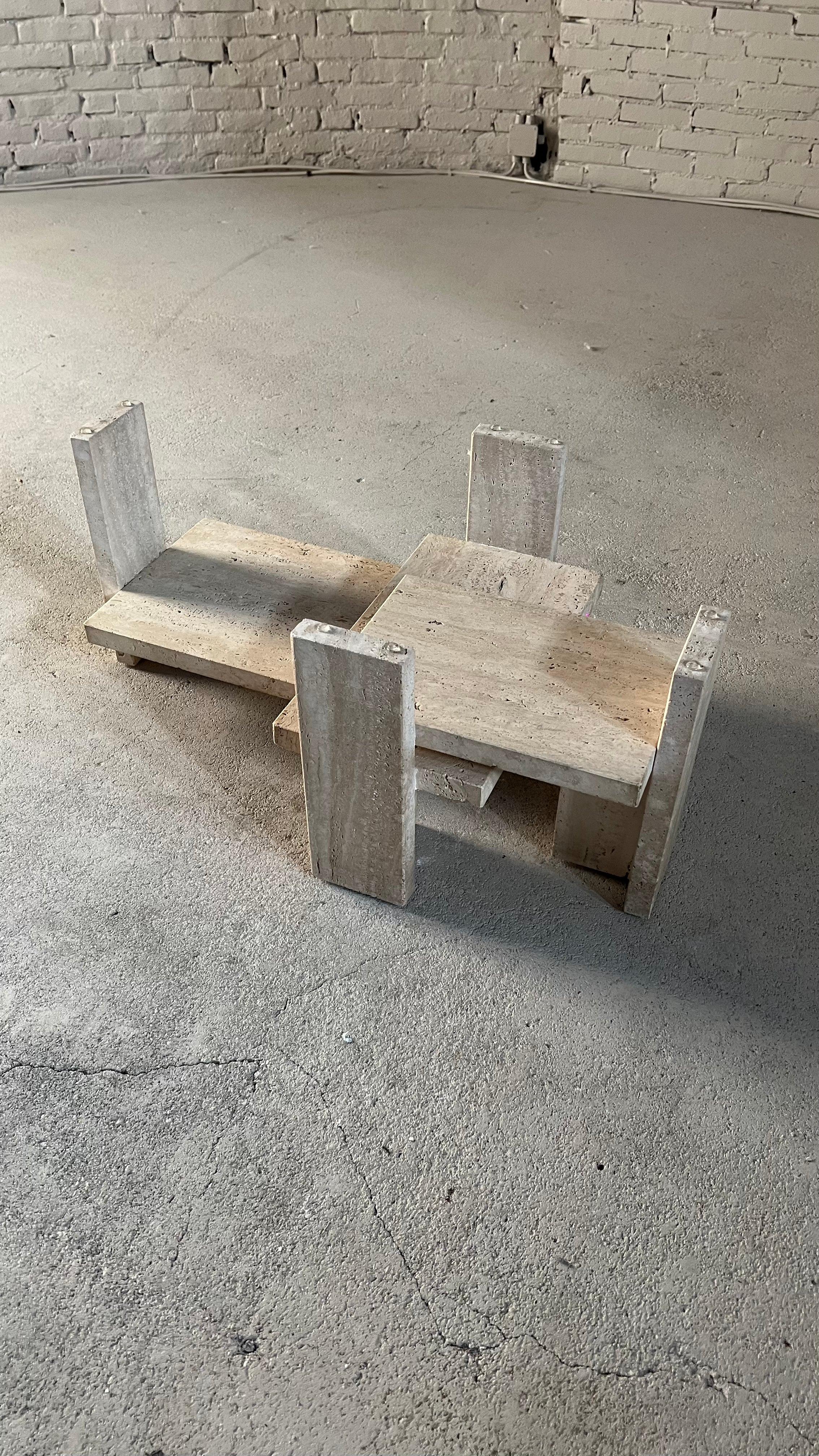 Architectural coffee table made from a solid travertine base. The table was designed by Willy Ballez in Belgium during the 1970's. All these tables are handmade, so they are always a bit different. The modern design mixes well in the current