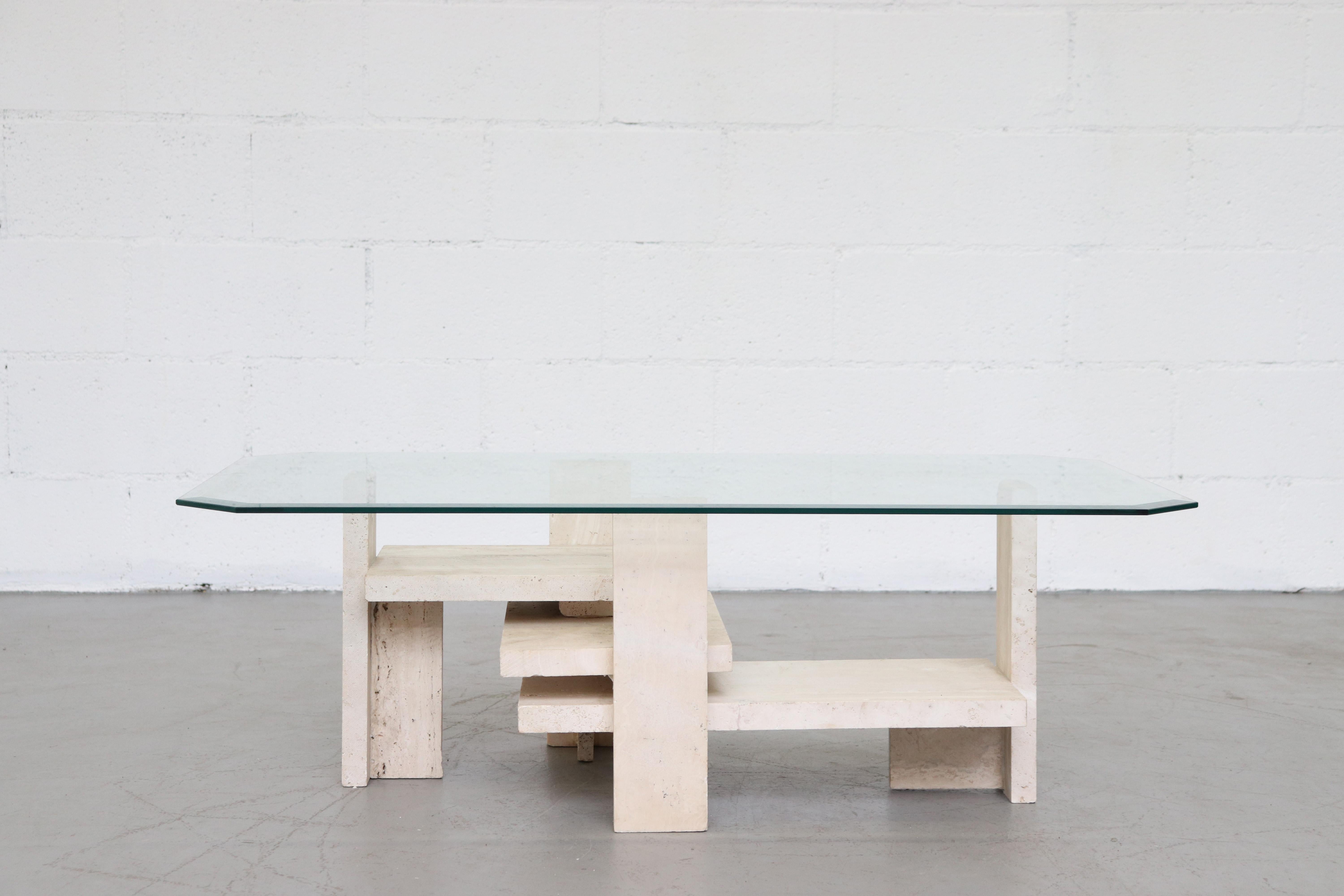 Modernist travertine and bevelled glass coffee table by Willy Ballez, 1970s, Belgium. Ballez has renown as a sculptor but was the designer of some highly architectural tables, working mostly in granite or travertine. This piece is in original