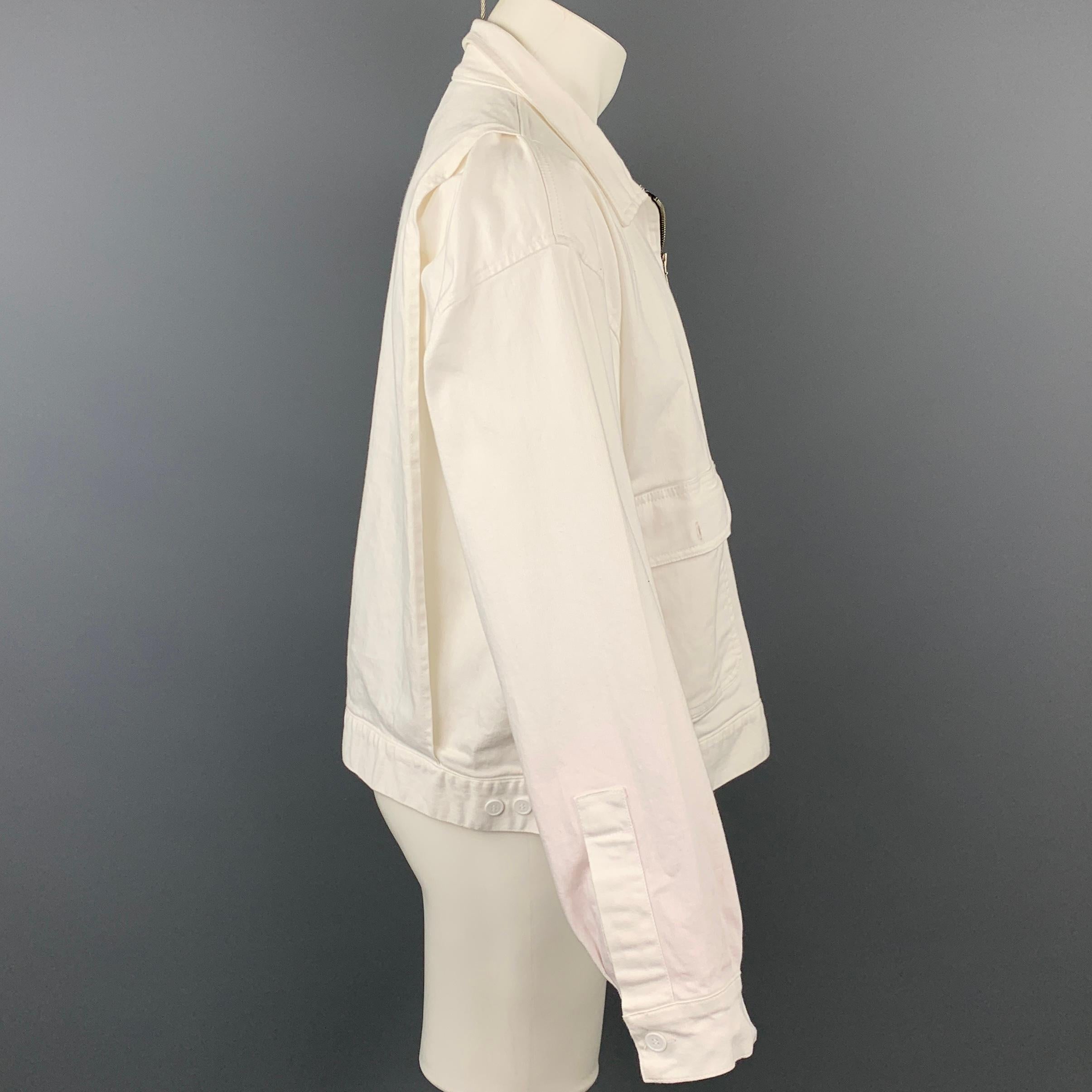 WILLY CHAVARRIA jacket comes in a white cotton featuring a front logo details, patch pockets, spread collar, and a zip up closure. Moderate wear.

Good Pre-Owned Condition.
Marked: No size marked

Measurements:

Shoulder: 24.5 in.
Chest: 46