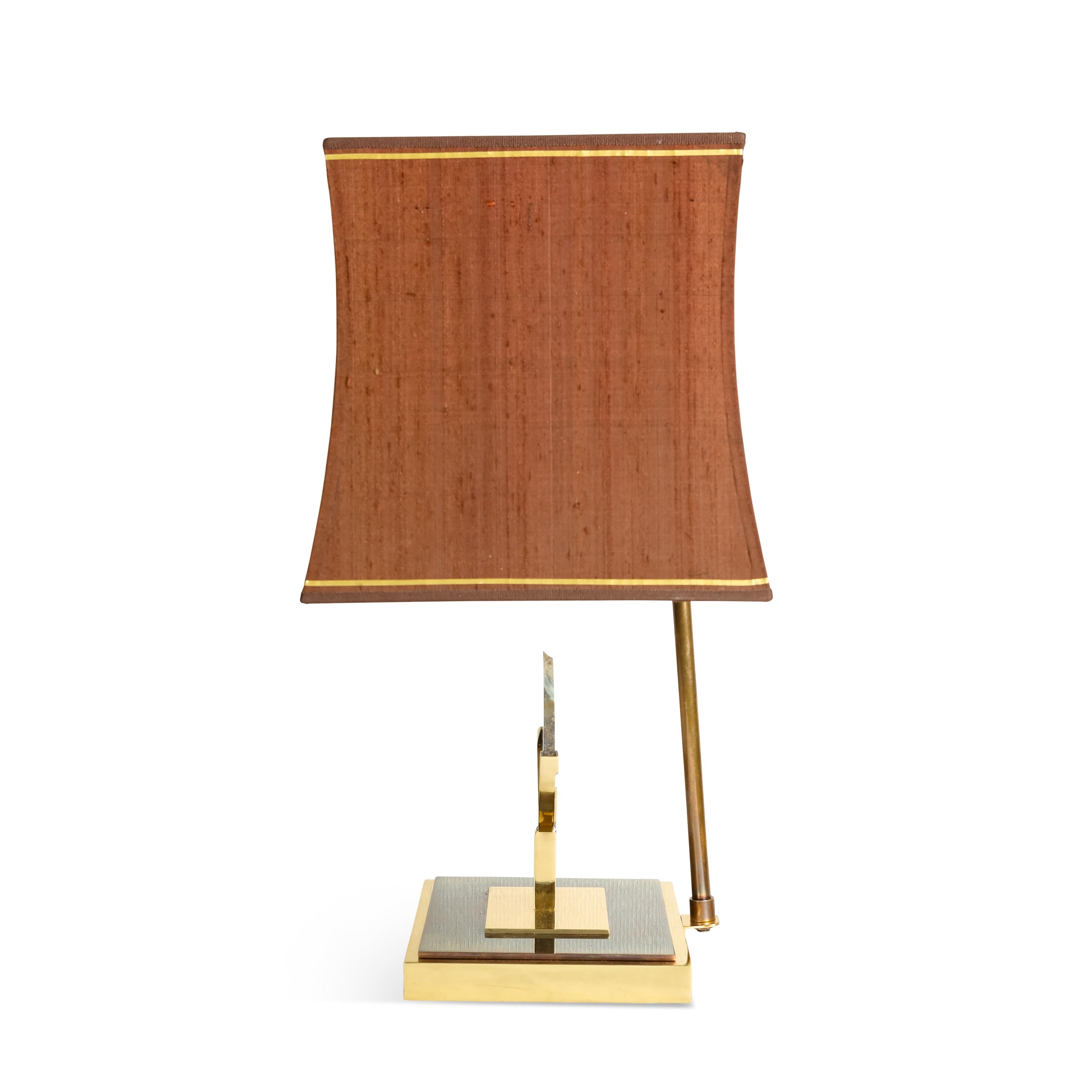 This very elegant  lamp is in brass with a rectangular base with 2 tones and an agate stone held by  brass clips. The lamp was professionally re-finished and its shade was custom made with a gold trim. The lamp has been American wired with two