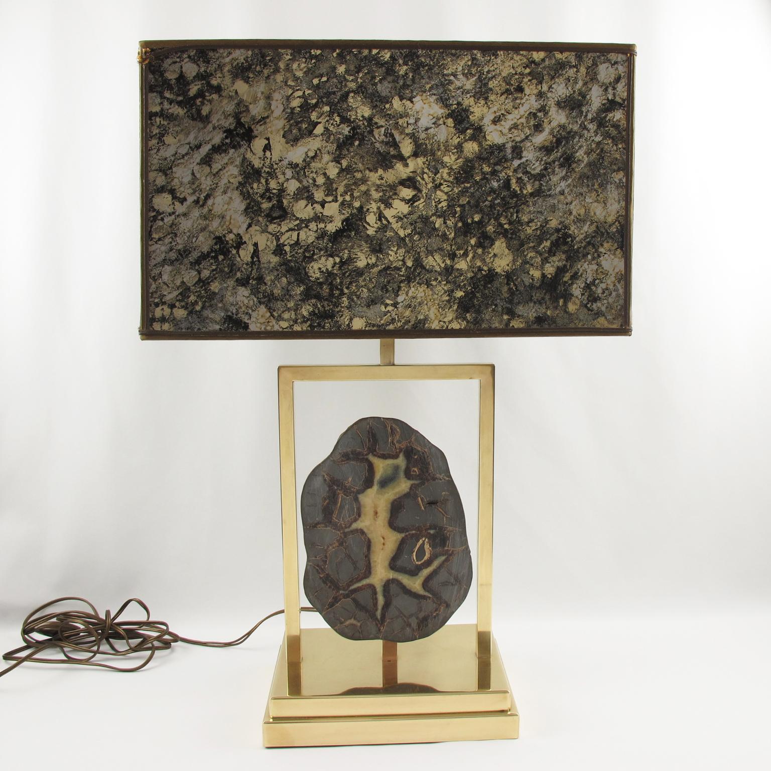 Willy Daro, Belgium, designed this elegant table lamp in the 1970s. The massive polished brass structure has an impressive Dragon Septarian geode stone slab. The original vintage shade, still present, boasts an incredible textured pattern with
