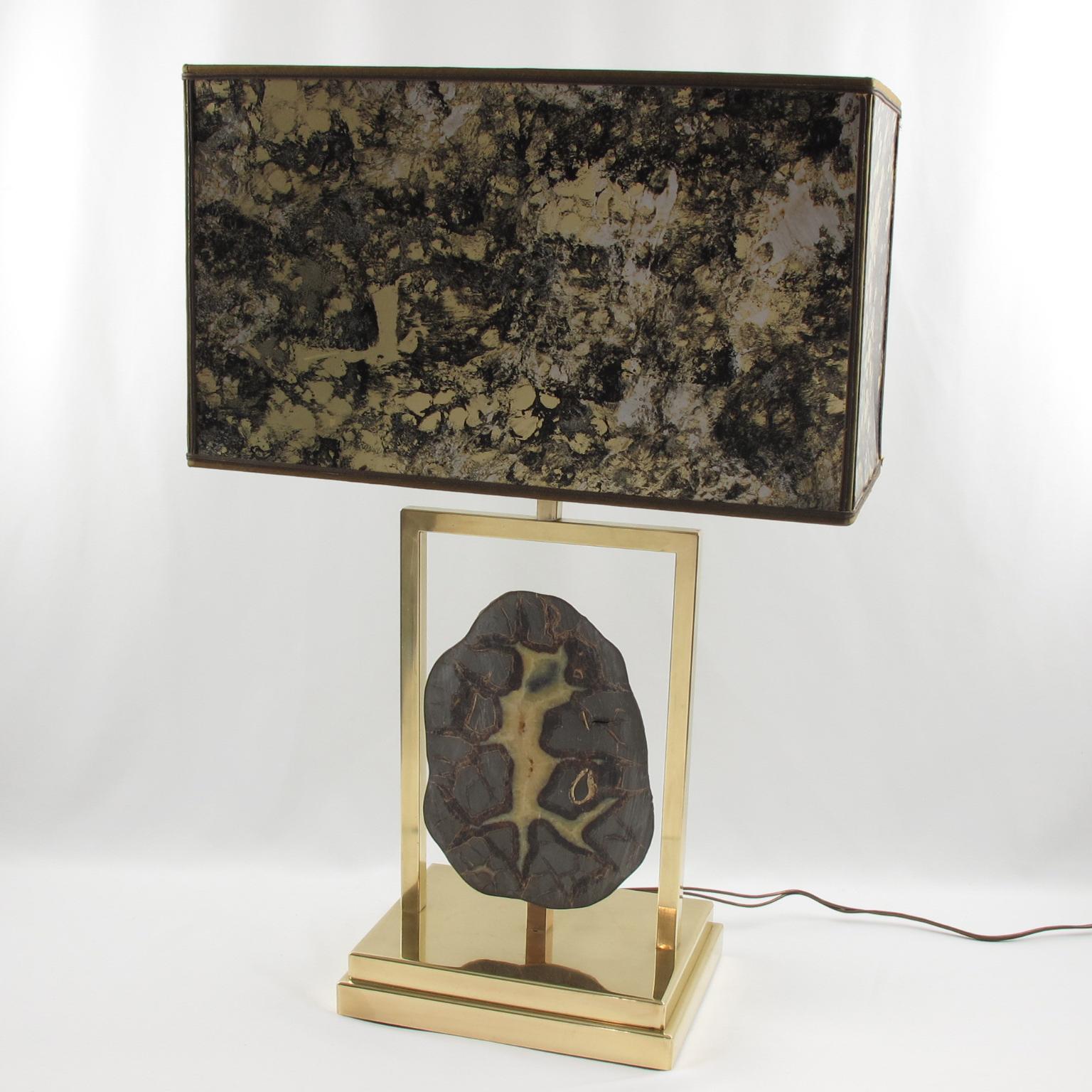 Willy Daro, Belgium, designed this elegant table lamp in the 1970s. The massive polished brass structure has an impressive Dragon Septarian geode stone slab. The original vintage shade, still present, boasts an incredible textured pattern with